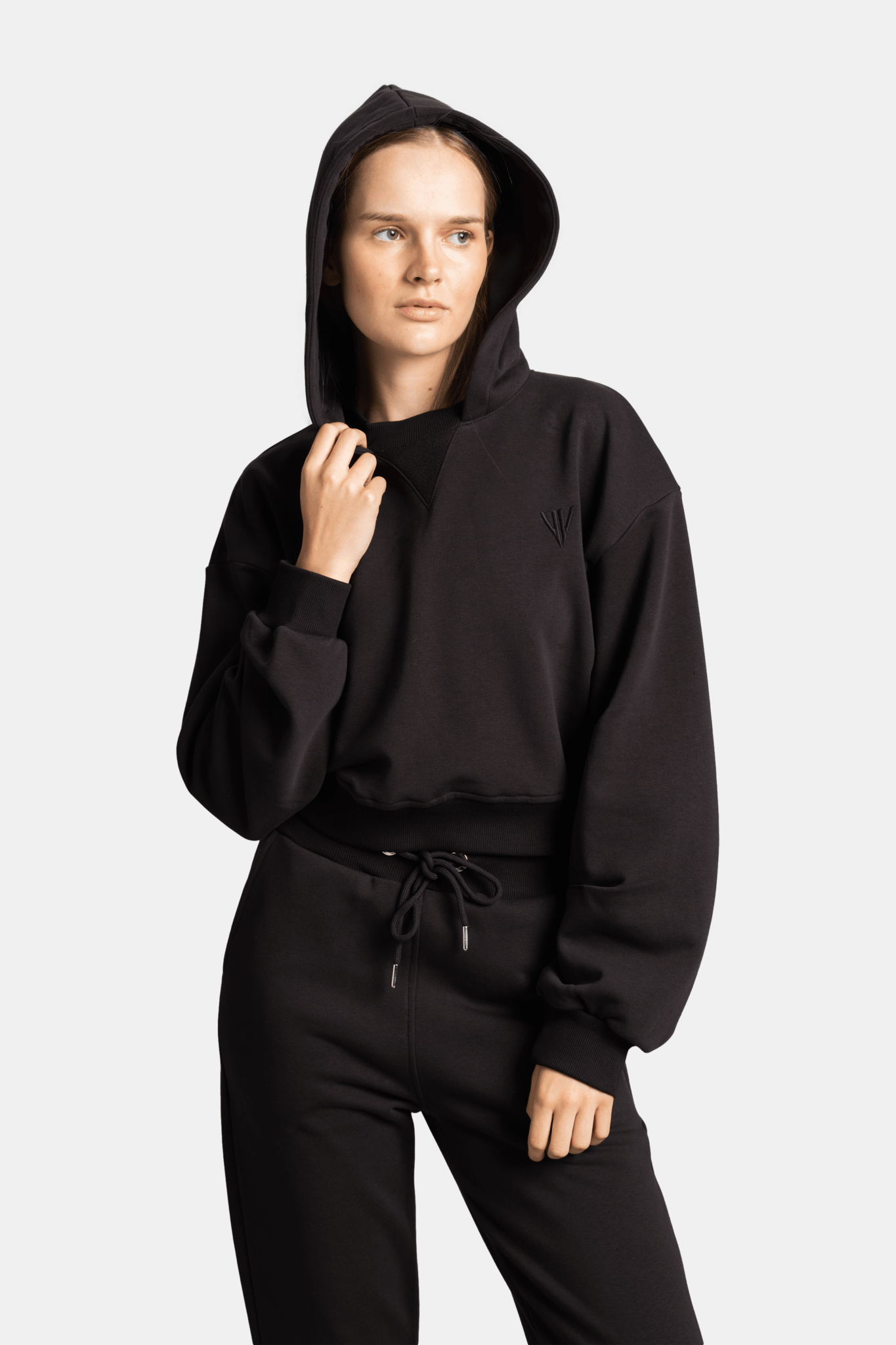 Full front view of model wearing the Lilot Tone on Tone black tracksuit, emphasizing casual elegance and fit