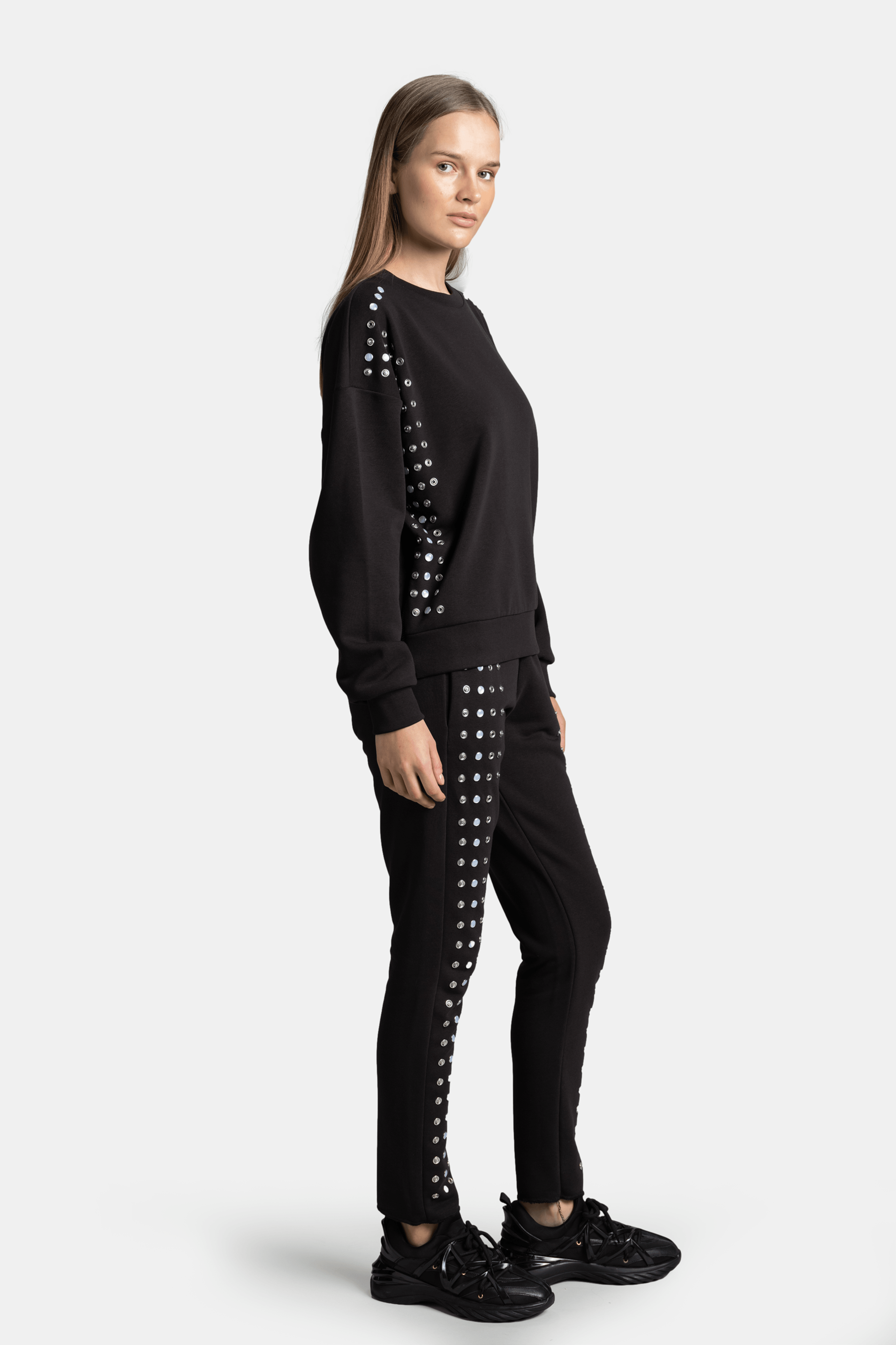 Amaya - Studded Tracksuit Set, side profile showing full length and side details of the black tracksuit.