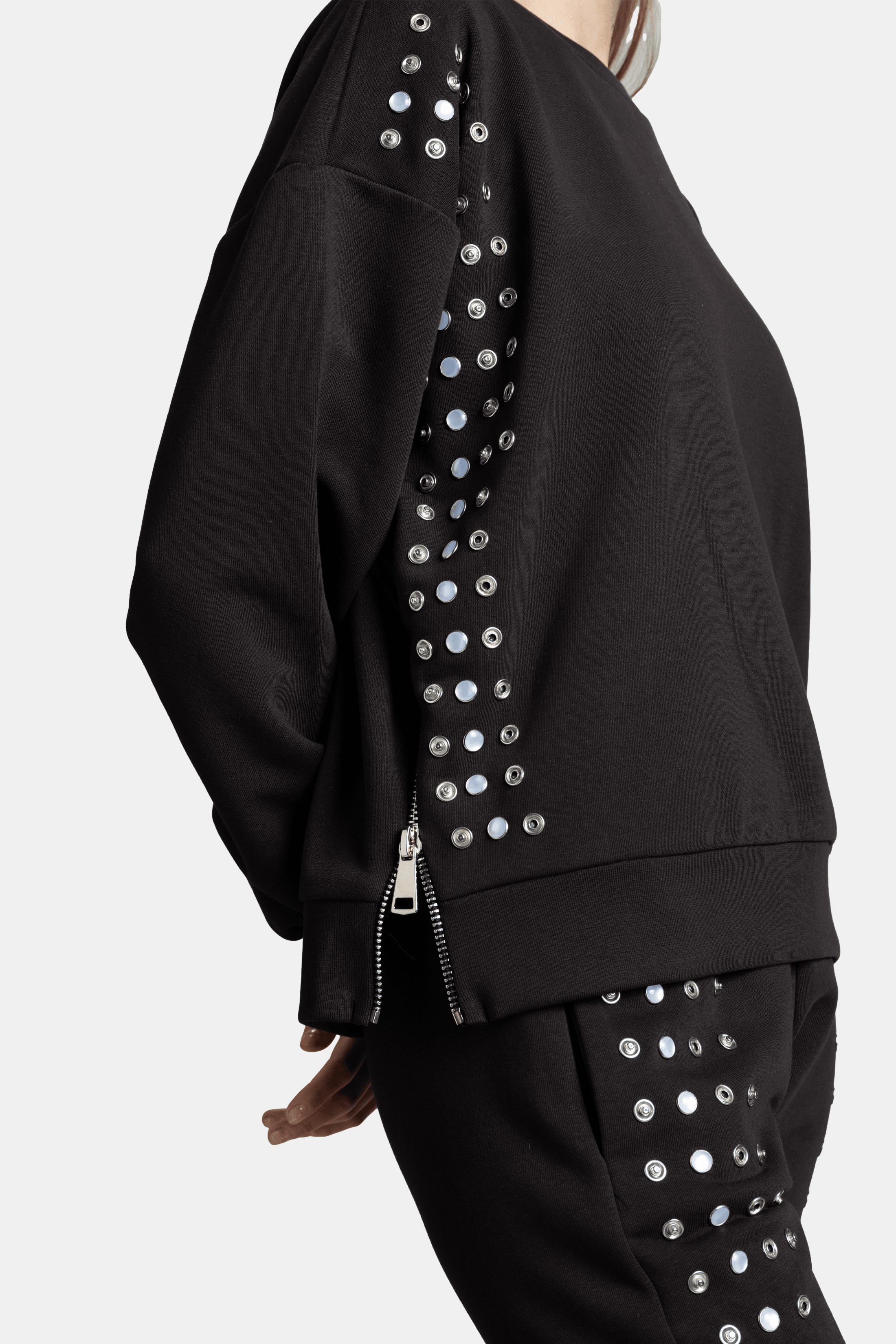 Amaya - Studded Tracksuit Set, close-up of pants with studded accents running along the sides.