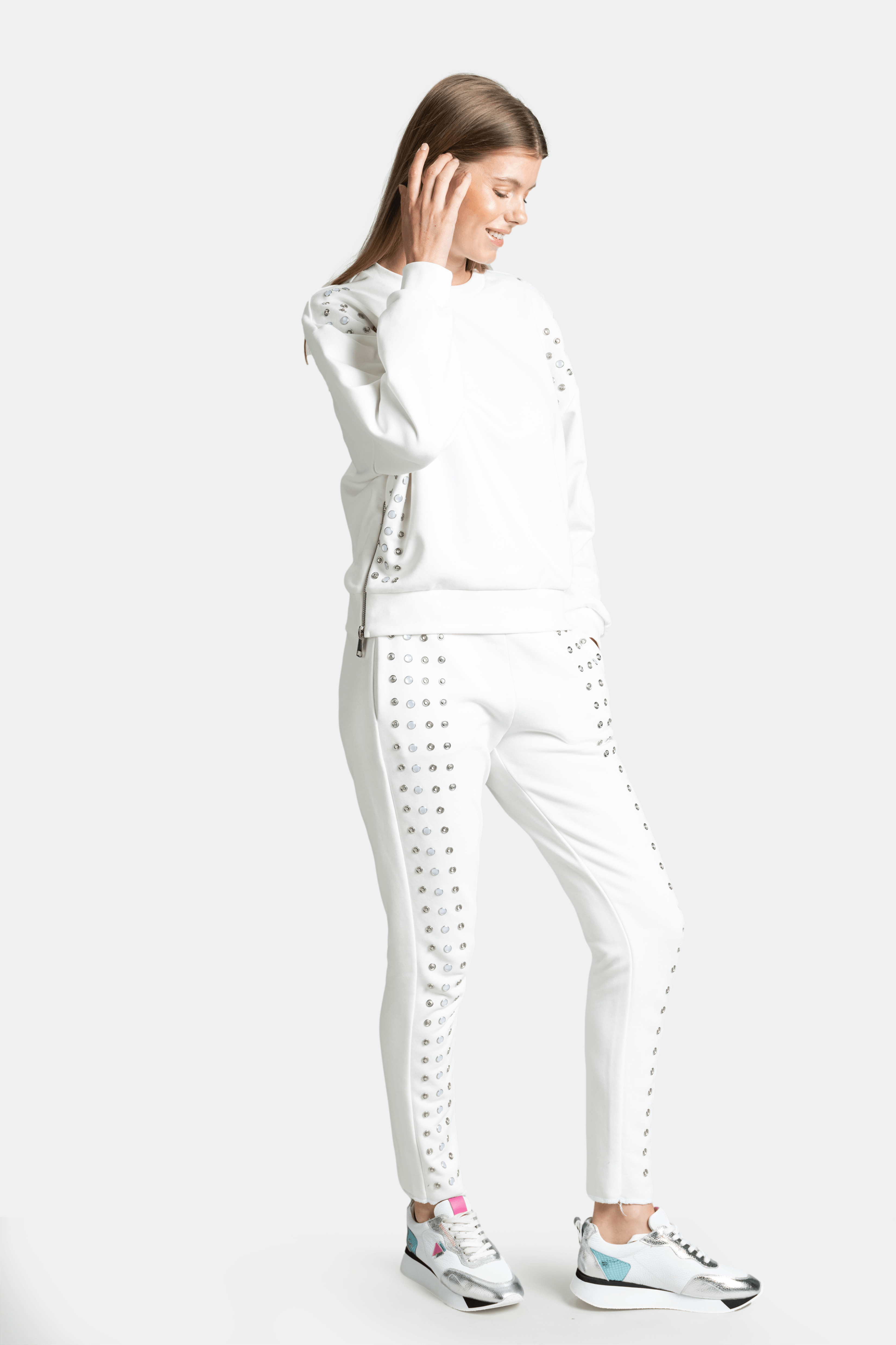 Amaya - Studded Tracksuit Set in Ecru, side view highlighting the detailed silver studs along the arms and legs.