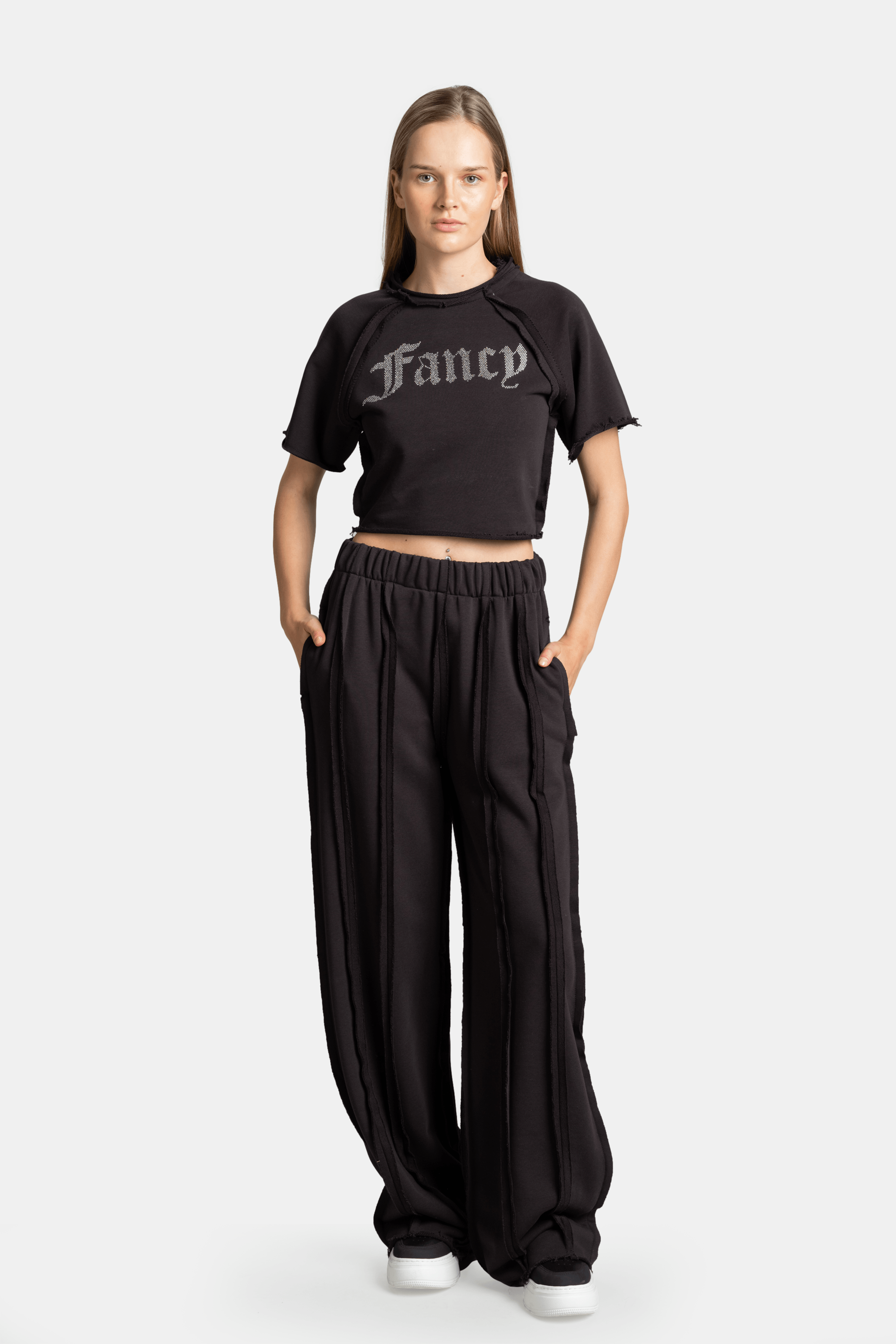 Front view of Amira - Fancy Crop Tracksuit Set in black, showing the cropped t-shirt with 'Fancy' text and matching high-waisted pants.