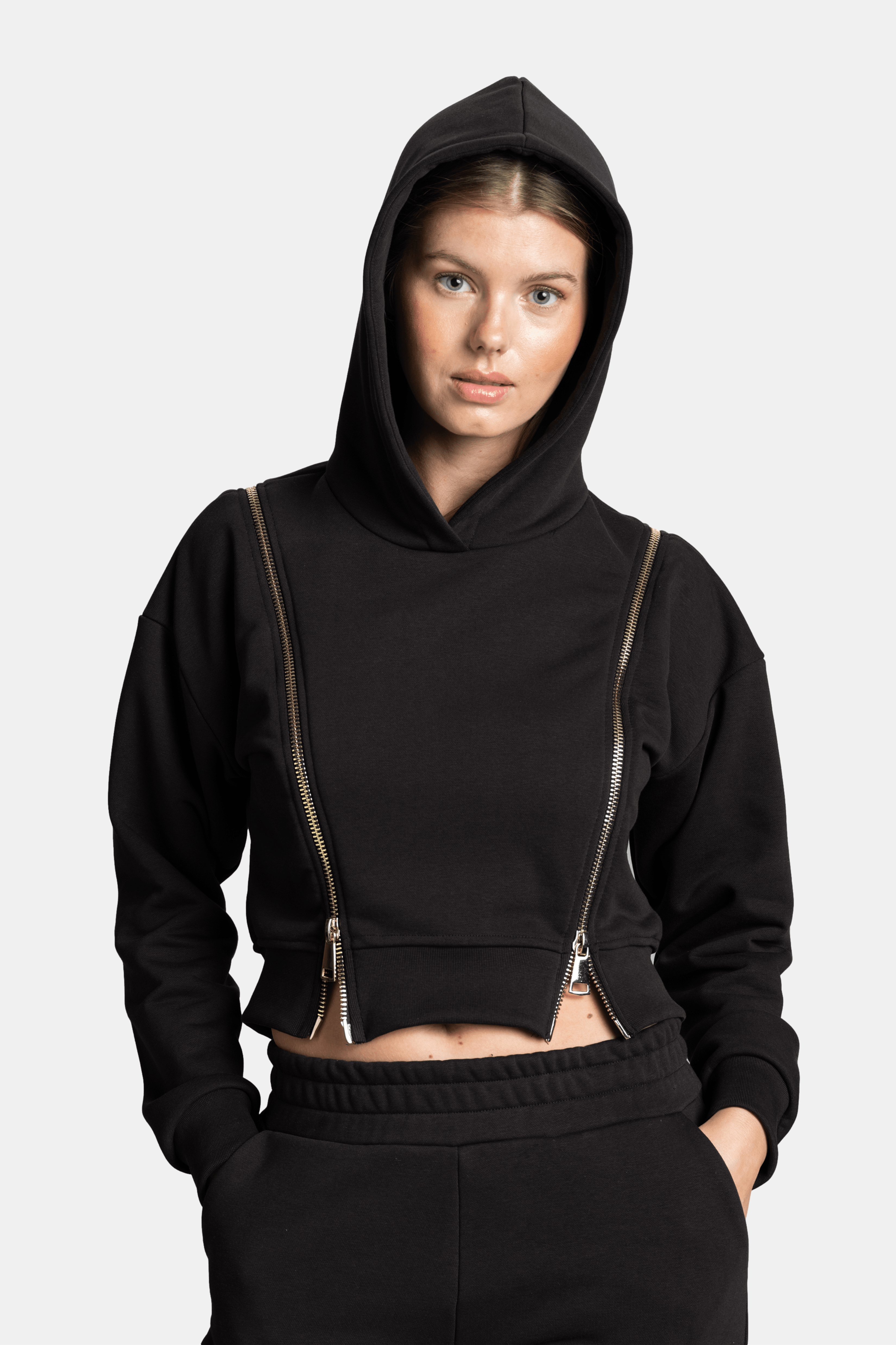 Close-up front view with hood up, displaying the zipper details on the Amina Tracksuit Set in black