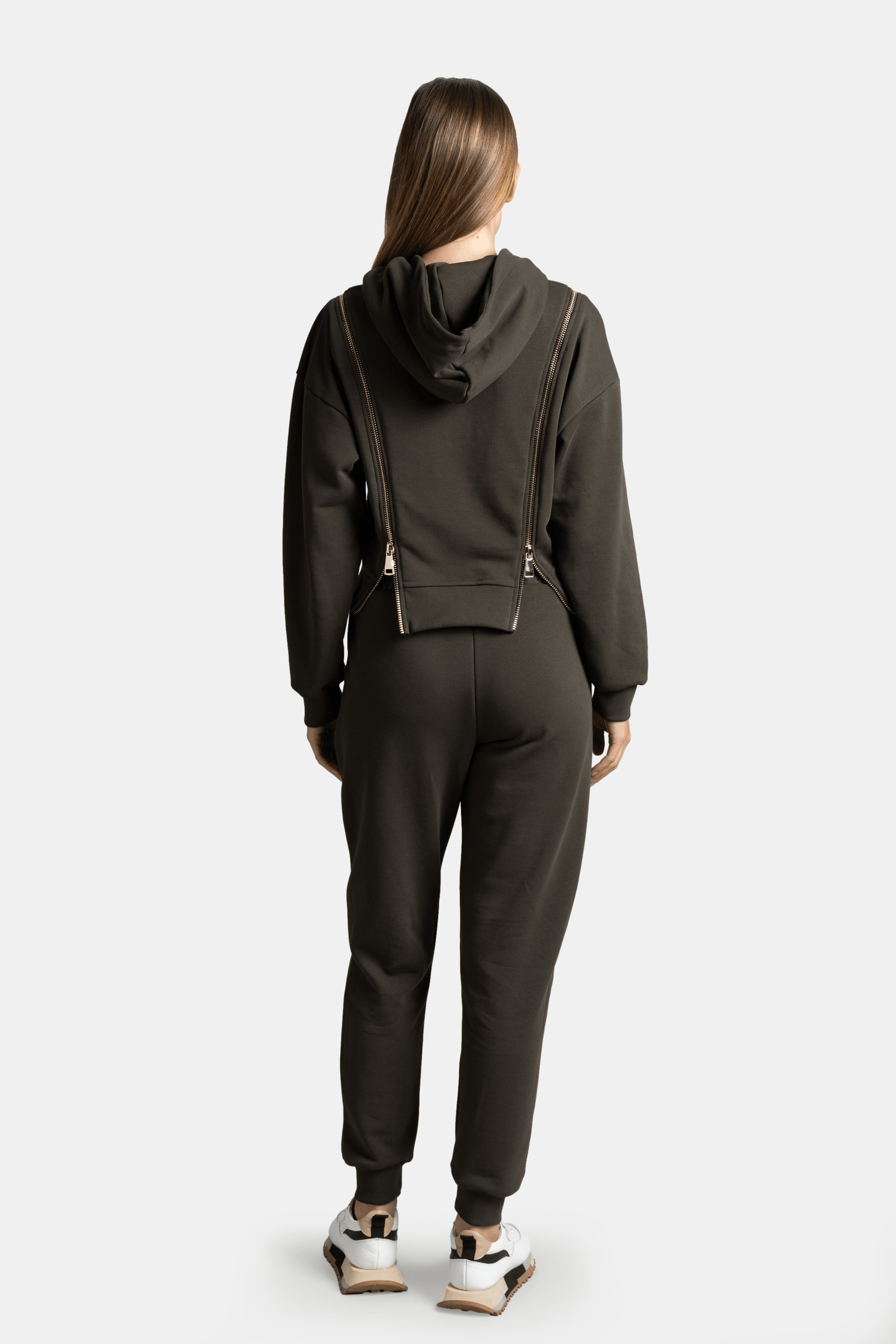 Back view of the Amina - Zip Detail Tracksuit Set in khaki, highlighting the hoodie design and the comfortable fit of the pants.