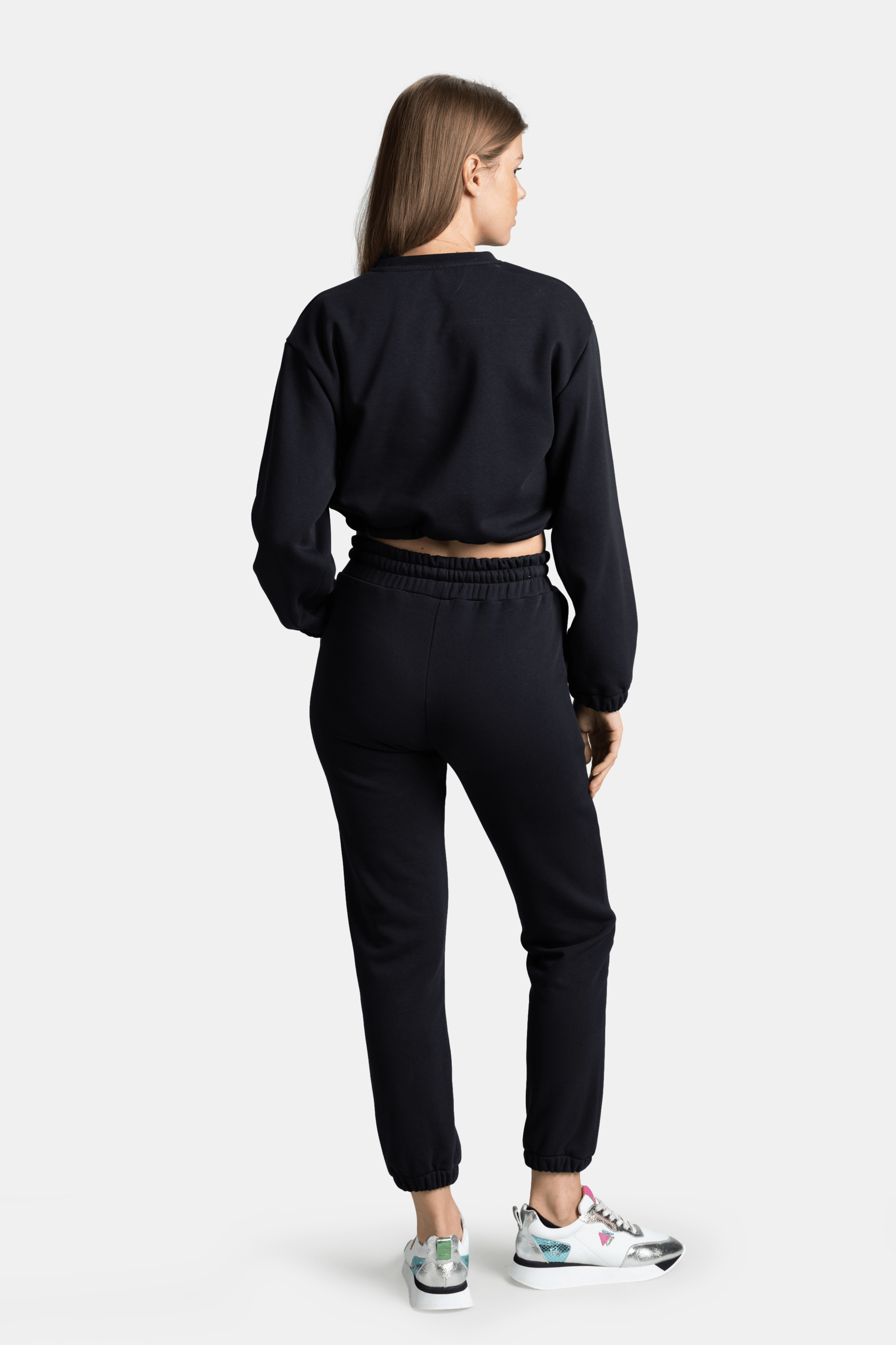 Back view of Almila - Modern Crop Tracksuit Set in Navy, highlighting the relaxed fit and cuffed ankles for a contemporary look.