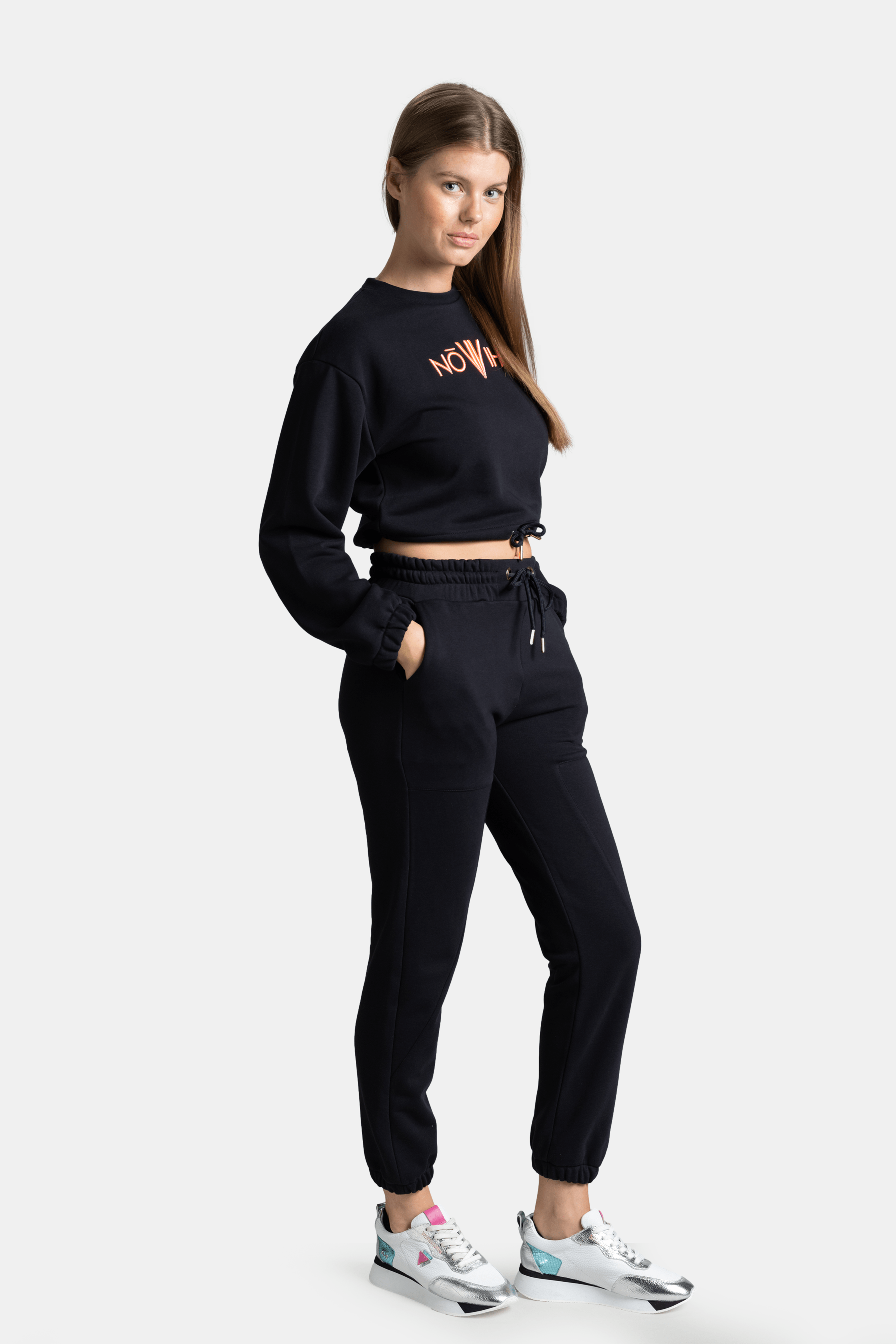 Side profile of Almila - Modern Crop Tracksuit Set in Navy, emphasizing the cropped sweatshirt design and adjustable drawstring waist.