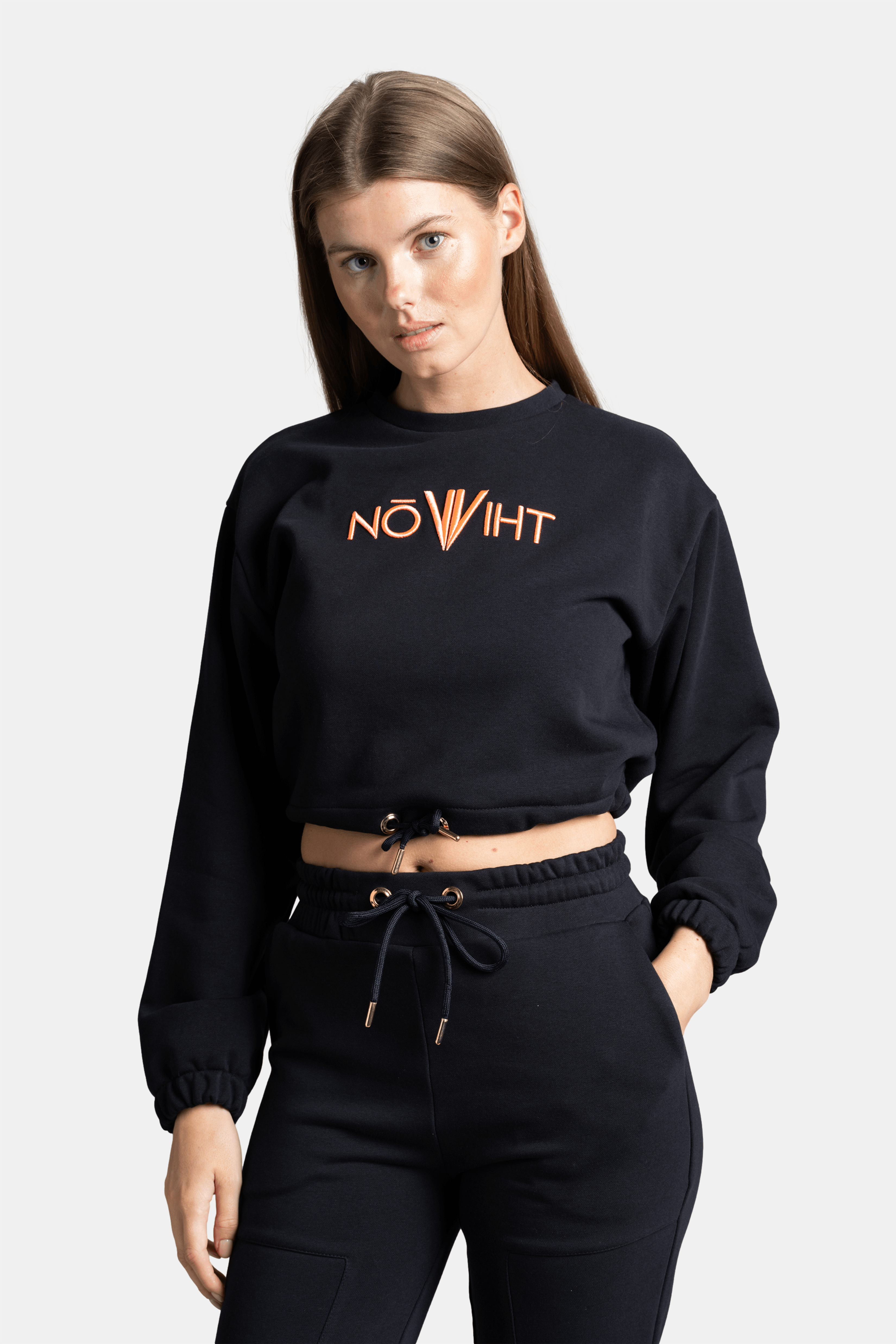 Close-up of the NOWIHT logo on Almila - Modern Crop Tracksuit Set, displaying the detailed embroidery on the navy cropped top.