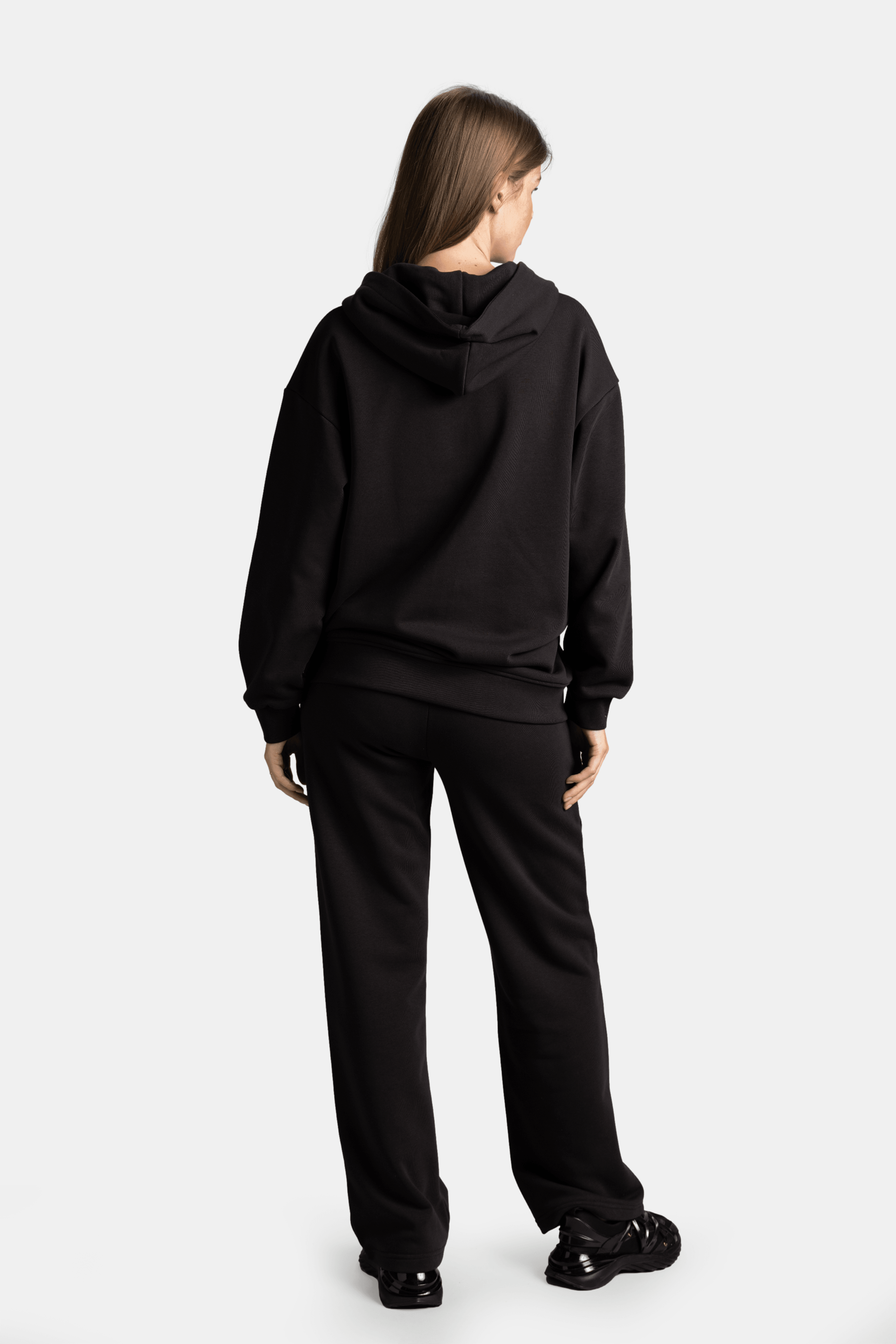 Brianna - Zipper Tracksuit Set in Black - Back view highlighting the hoodie design and straight-leg pants