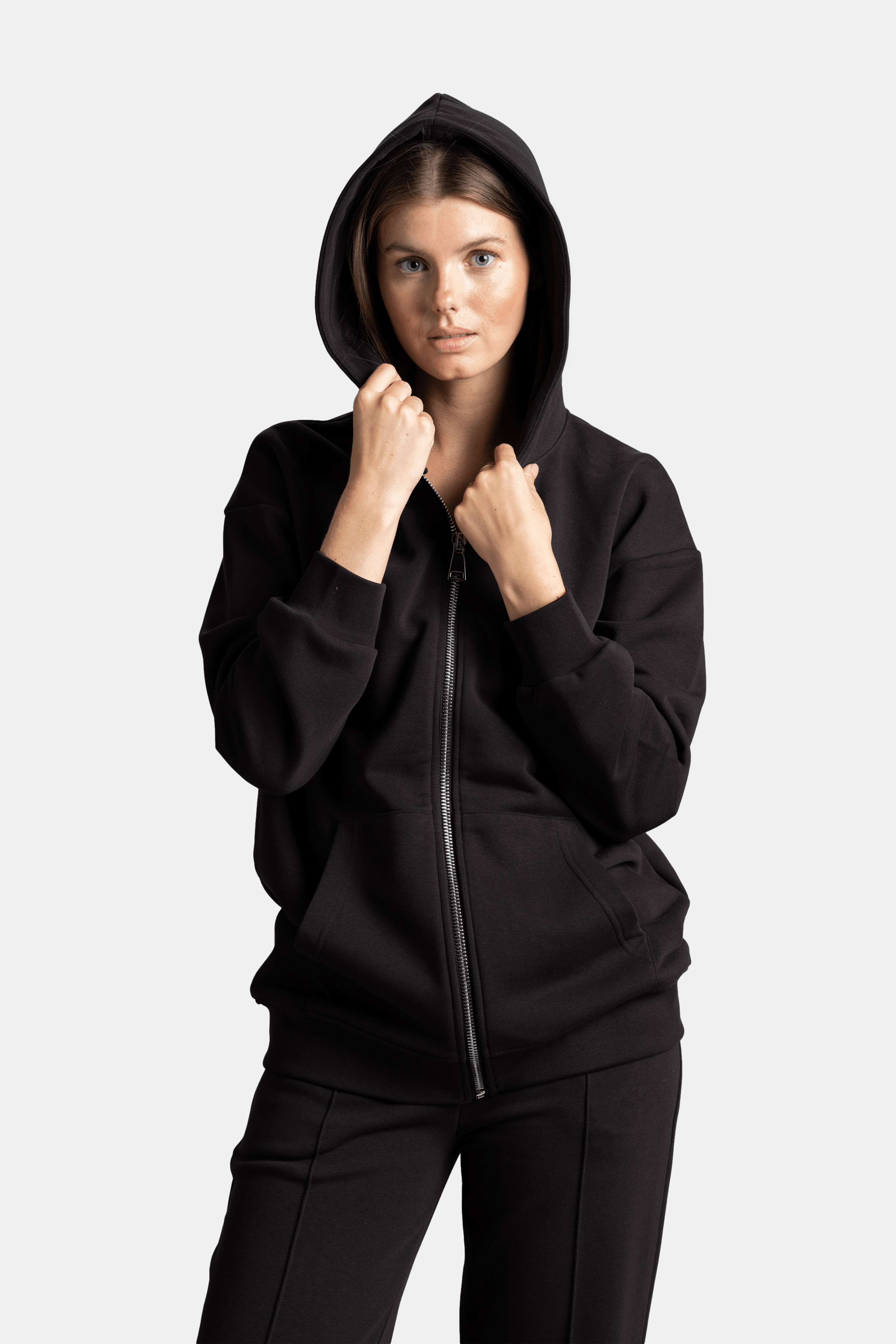 Brianna - Zipper Tracksuit Set in Black - Close-up of the hoodie with the hood up, showing the zipper detail