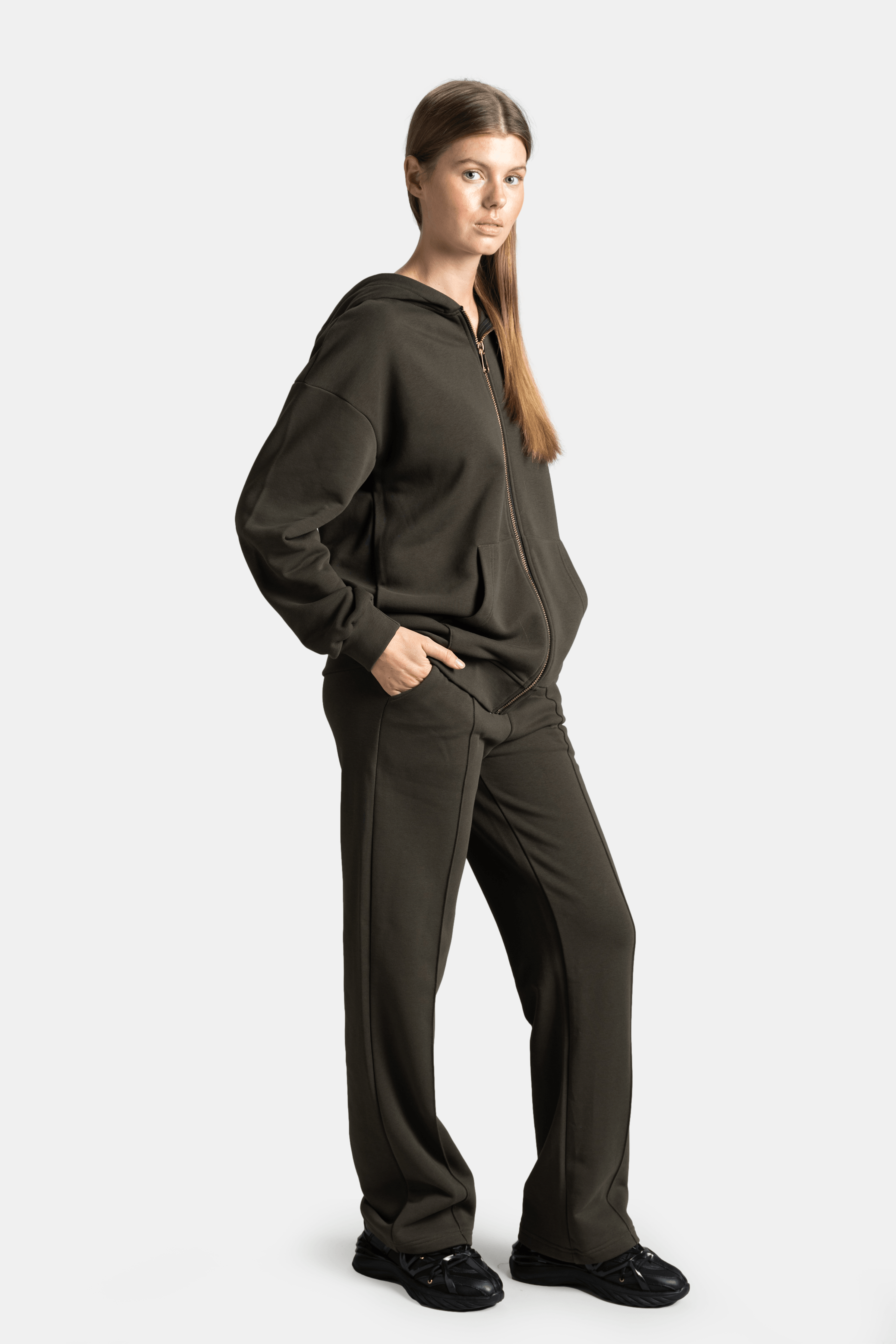 Brianna - Zipper Tracksuit Set in Khaki - Side profile with hands in pockets, displaying the hoodie and pants fit