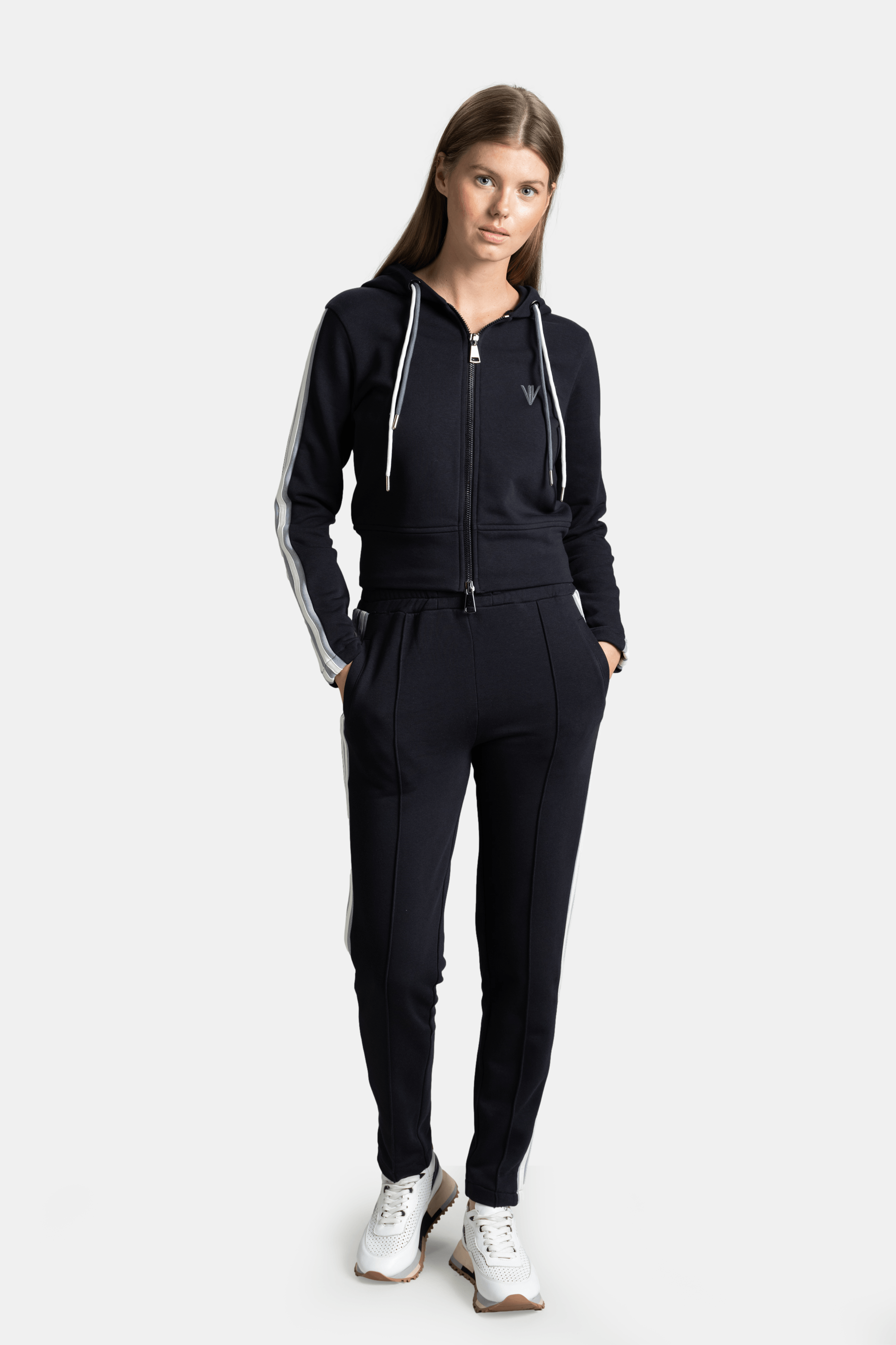 Callista - Sporty Zipper Tracksuit Set in Navy, front view with model standing hands in pockets, showcasing Nowiht branding on chest and sporty side stripes.