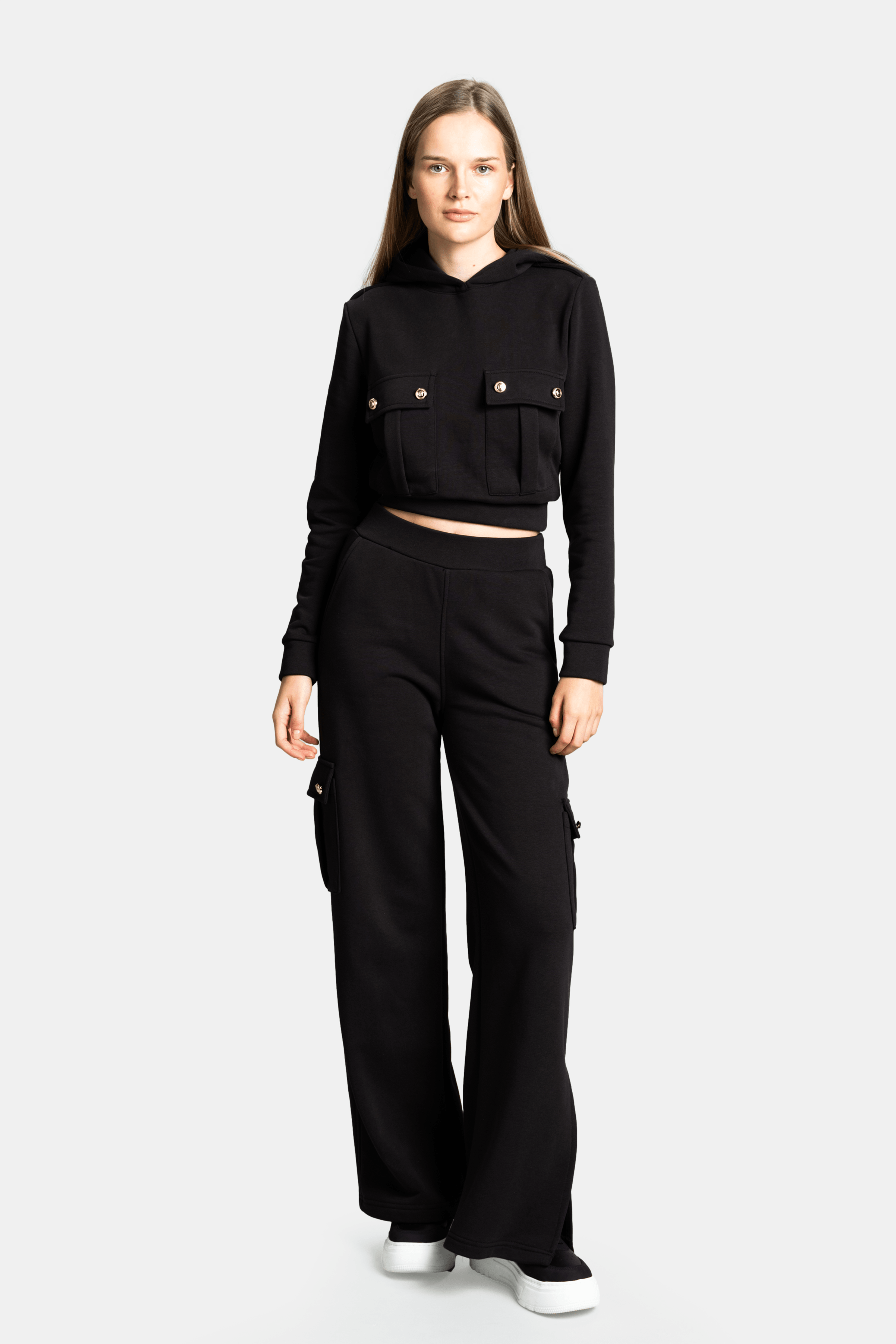 Cambria - Pocket Detail Tracksuit Set in Black, front view with model in a relaxed pose, highlighting the overall structure and modern appeal of this tracksuit set.