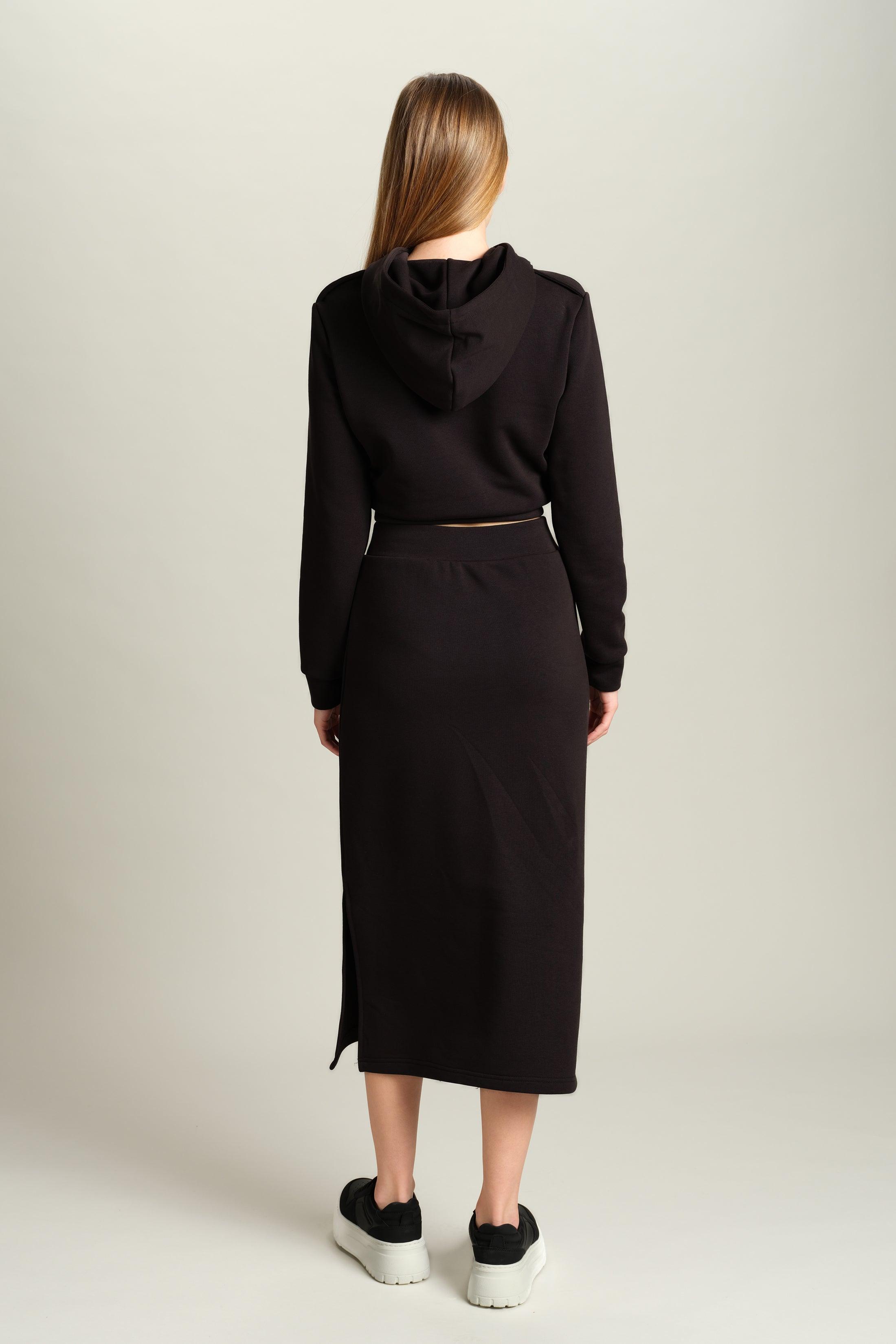 Capri - Pocket Detail Skirt Set in Black, back view showcasing the hooded top and sleek, form-fitting skirt, emphasizing the set’s stylish design from behind.