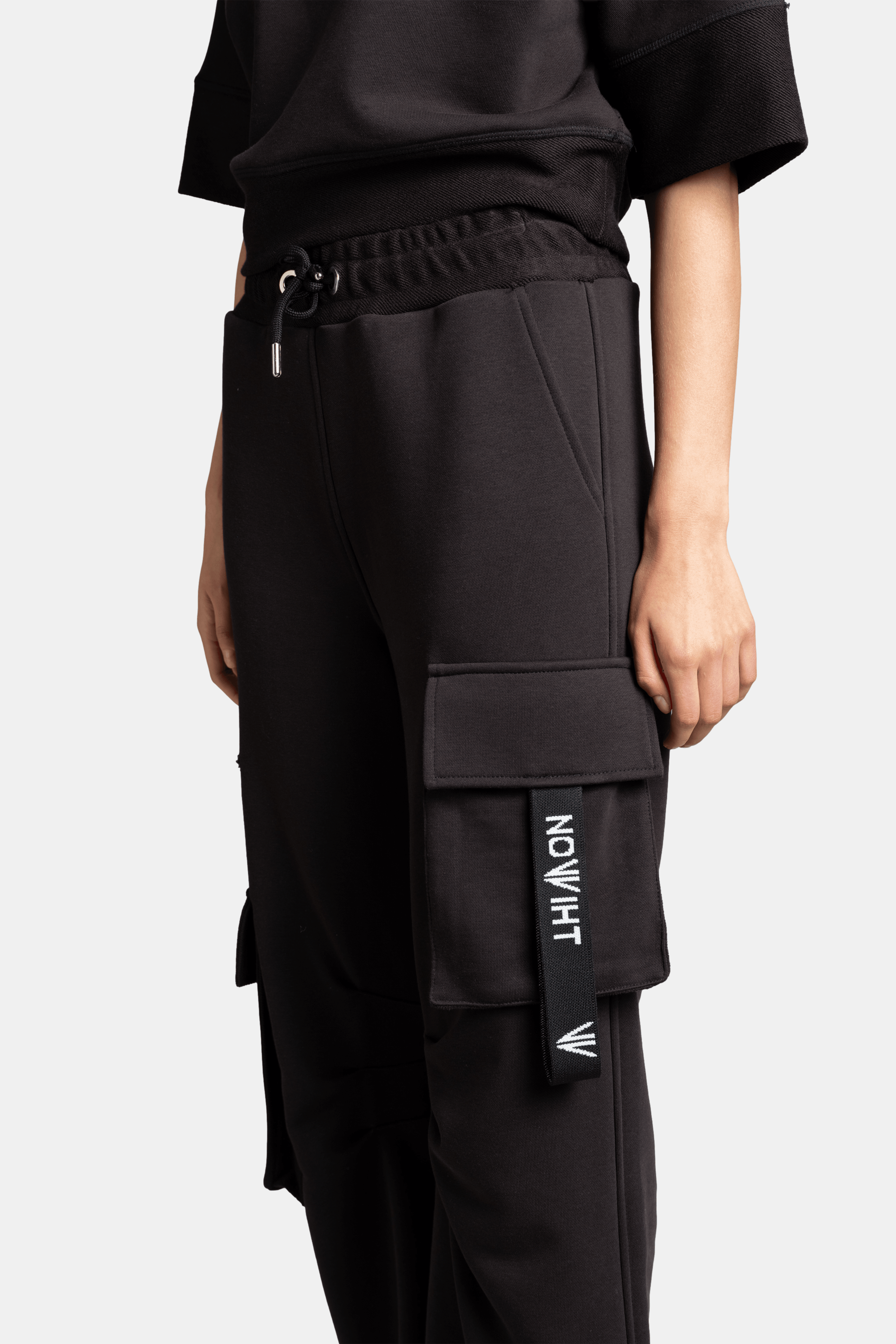 Meira - Cargo Jogger Tracksuit Set in Black, close-up of cargo pocket showing the Nowiht logo tag detail and the durable stitching, underscoring the premium quality.