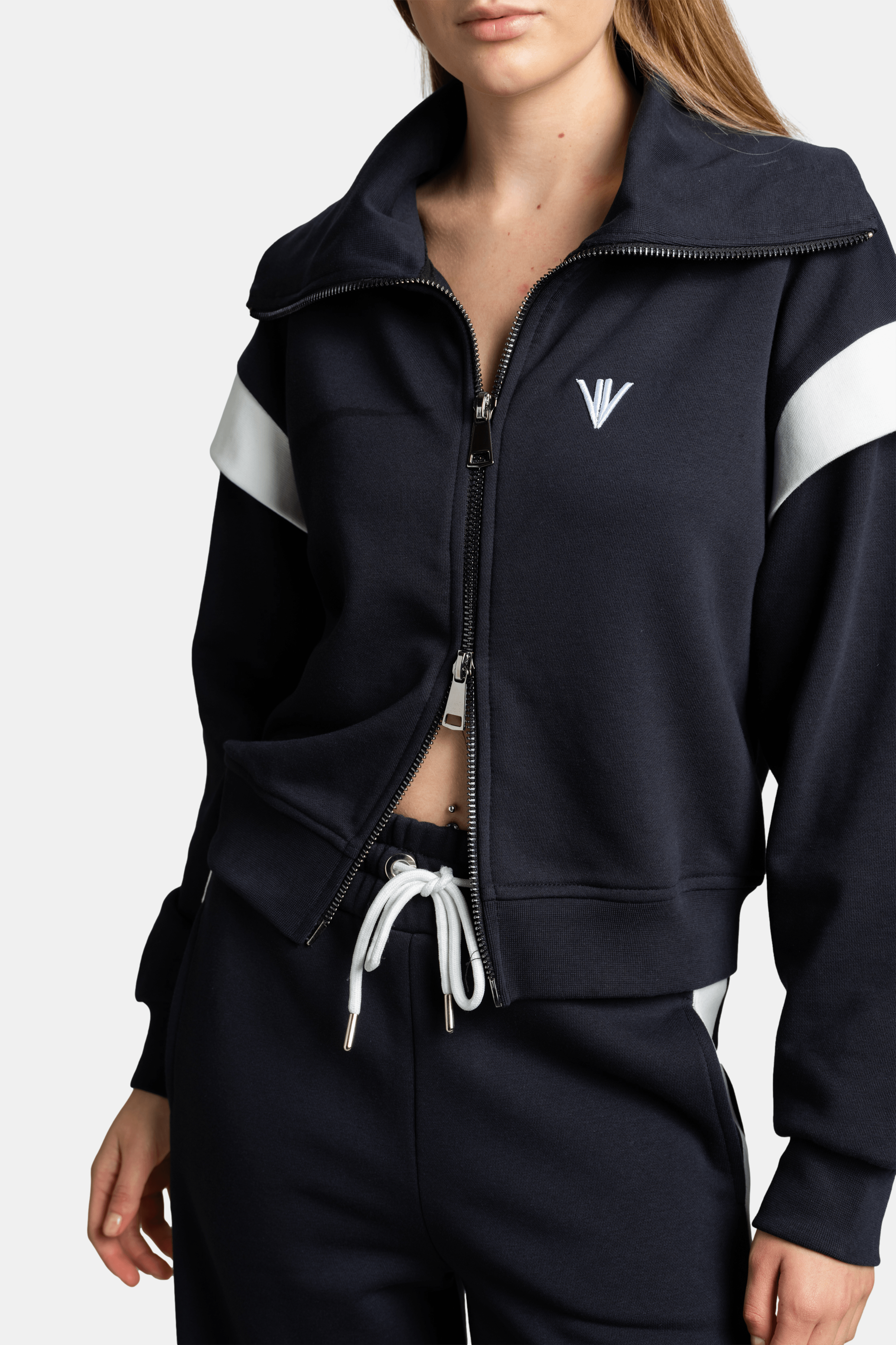 Detailed view of Ciara zip sweatshirt tracksuit set in gray, focusing on the zip-up collar and logo detail