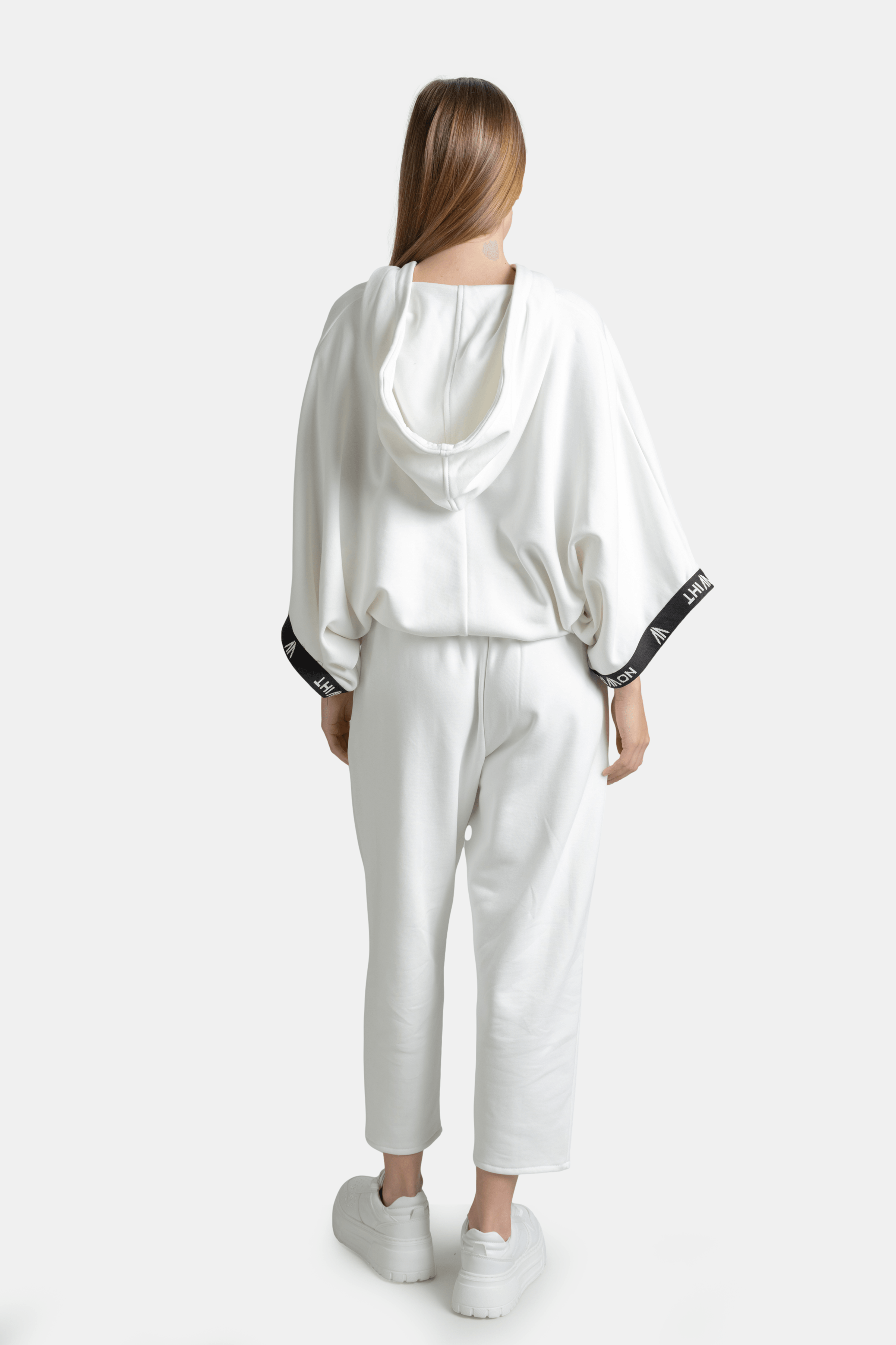 Back view of Elif - Parachute Sleeve Tracksuit Set in White, displaying the hooded design and NOWIHT logo on sleeve.