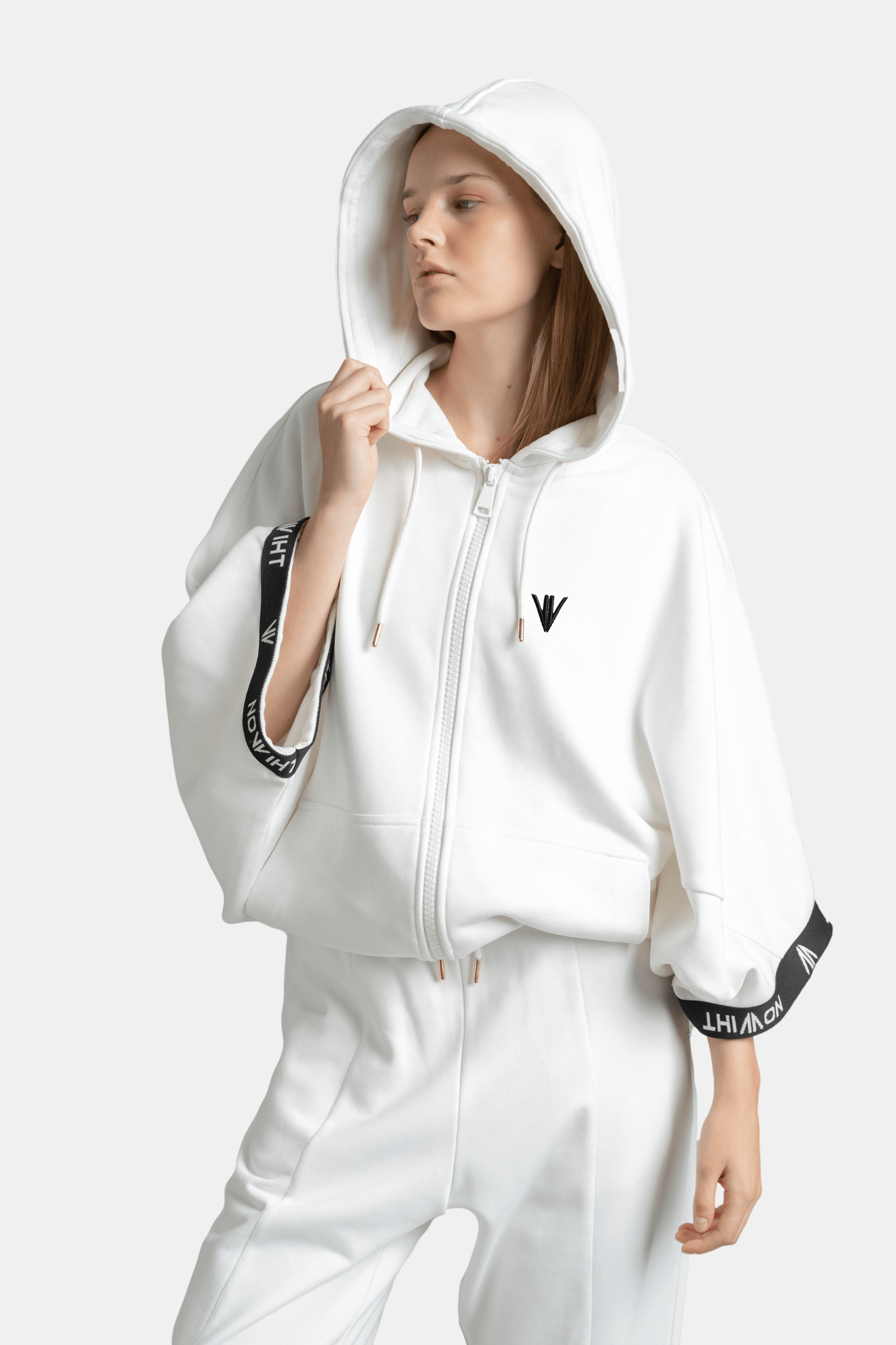 Elif - Parachute Sleeve Tracksuit Set in White, front view with hood on, showing off the sleek style.