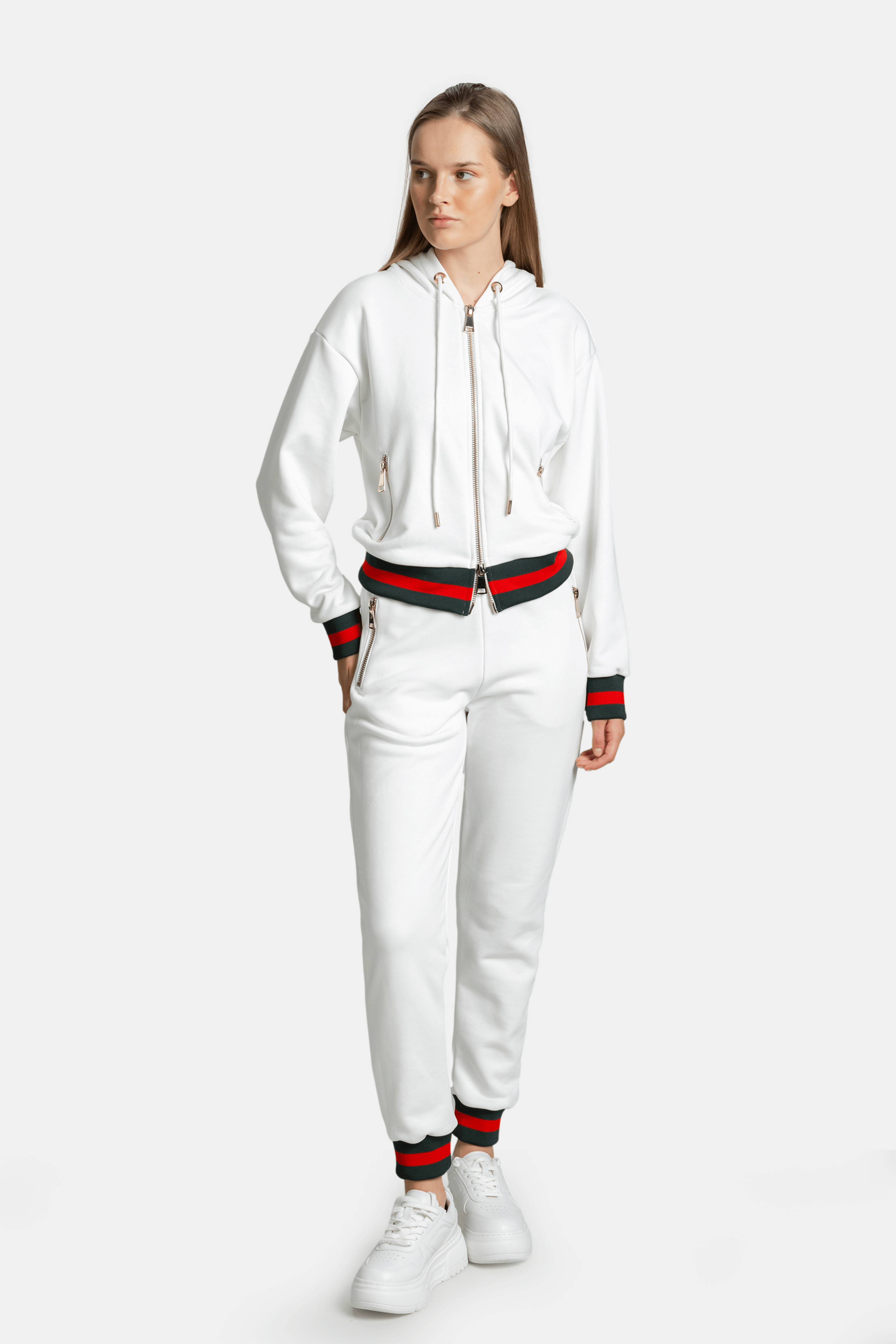 Full-body front view of model wearing white Destiny striped zip hoodie tracksuit set with green and red striped details