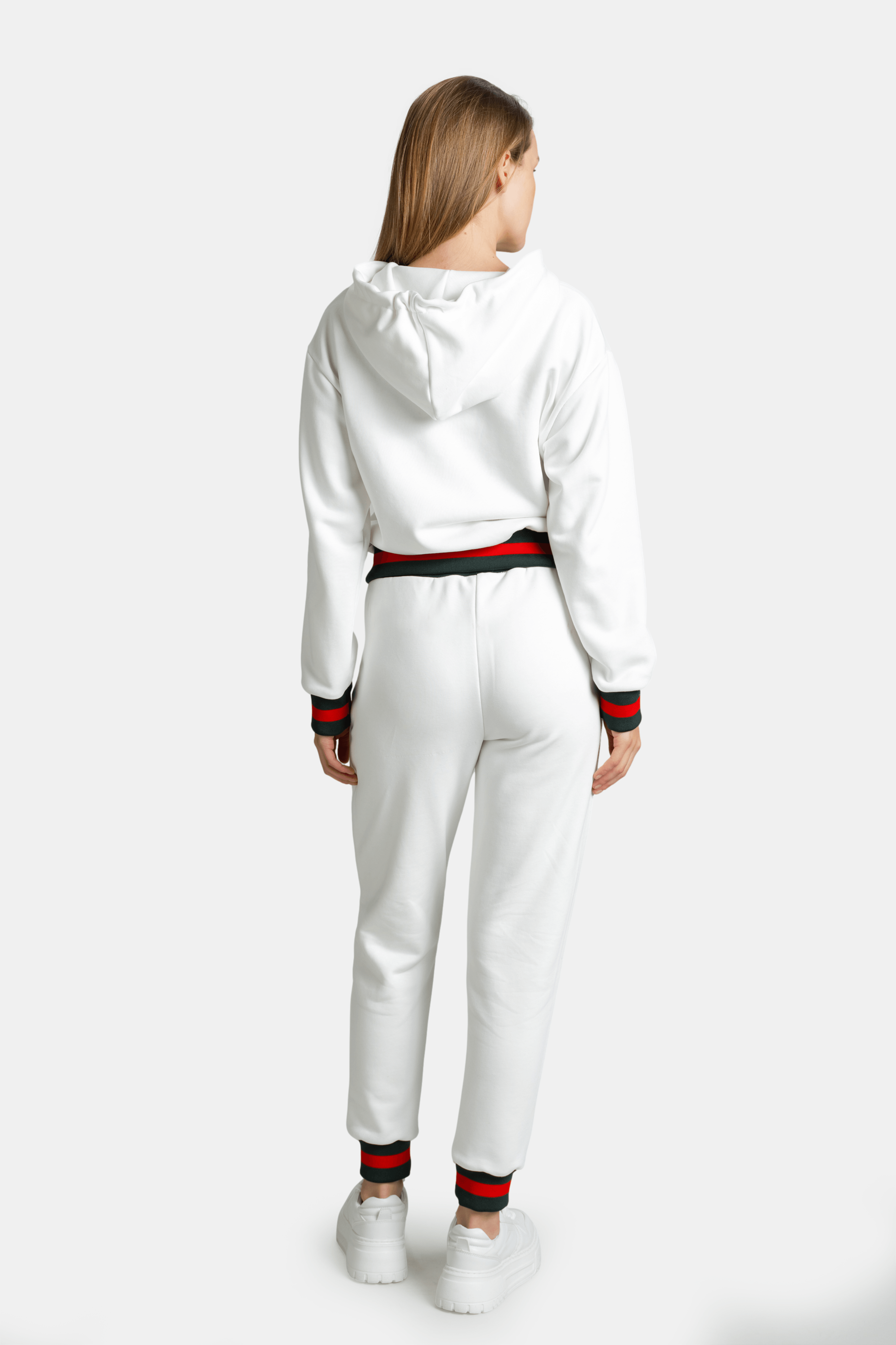 Back view of model in white Destiny striped zip hoodie tracksuit set showing hood and waistband