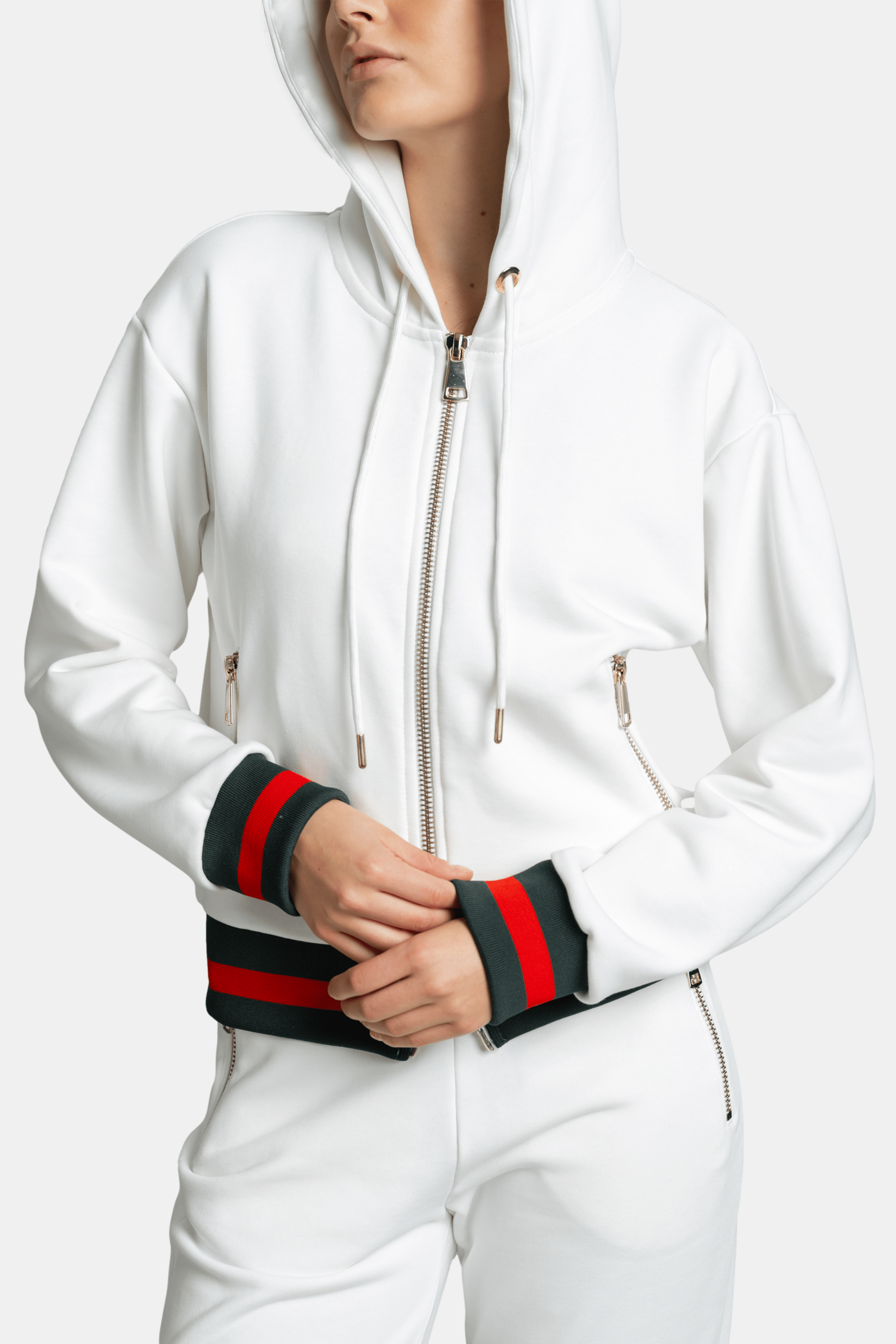 Close-up of model adjusting hood strings on white Destiny striped zip hoodie tracksuit set