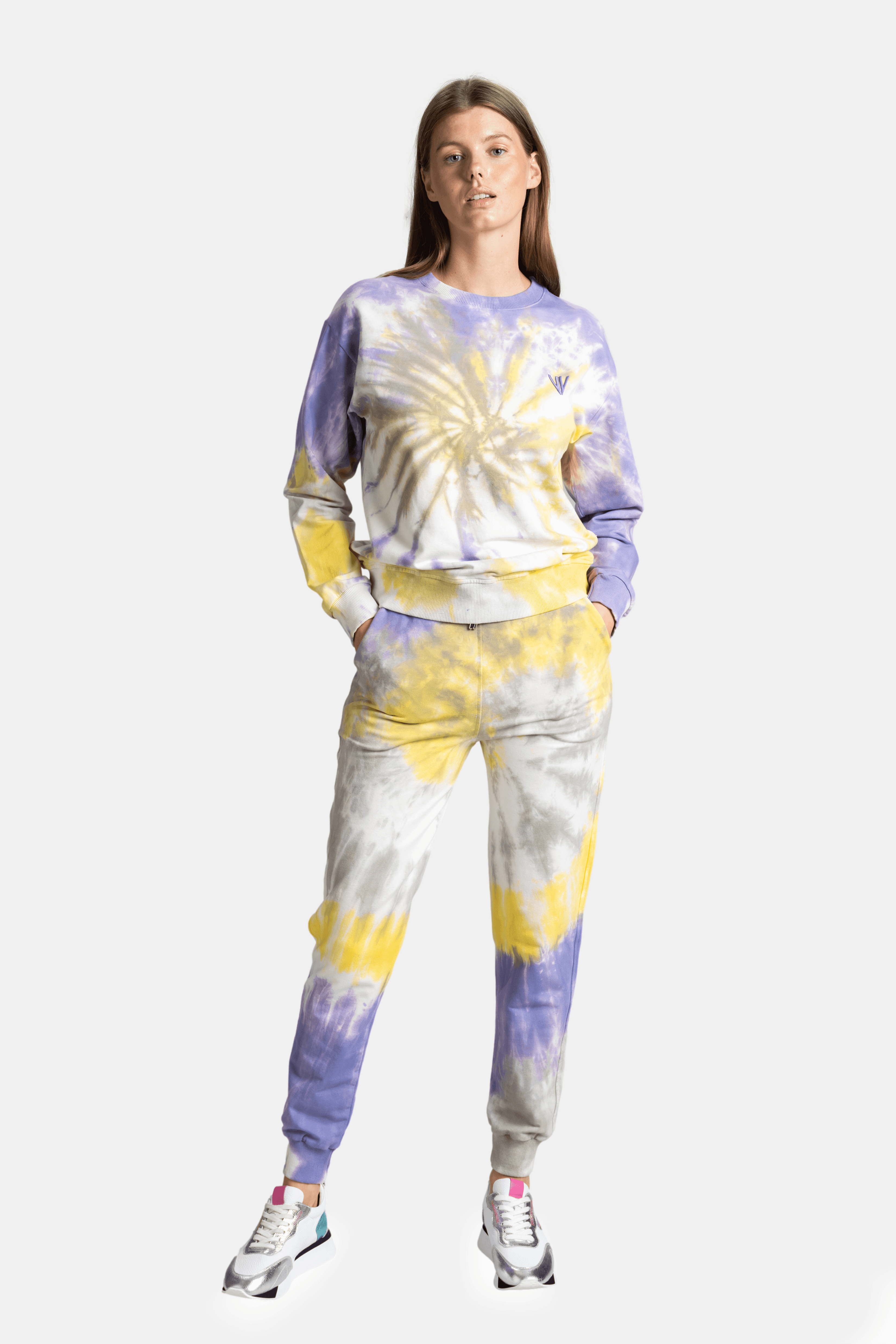 Colorful tie-dye sweatshirt and joggers set for women, blending yellow, purple, and white, a vibrant and comfortable outfit for relaxed days.