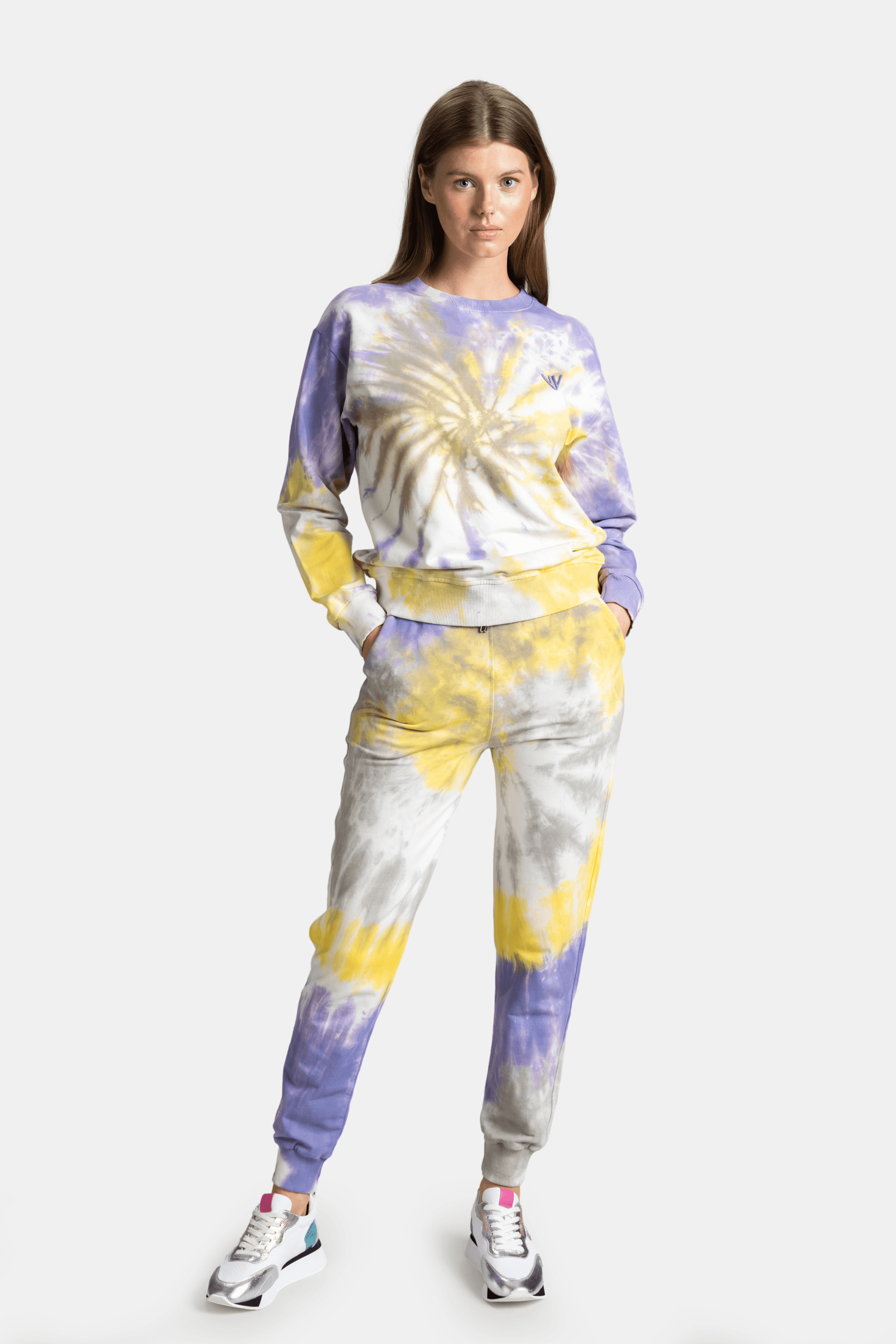 Women's tie-dye sweatshirt and joggers set in vibrant yellow, purple, and white tones, casual and stylish loungewear perfect for a trendy, relaxed look.