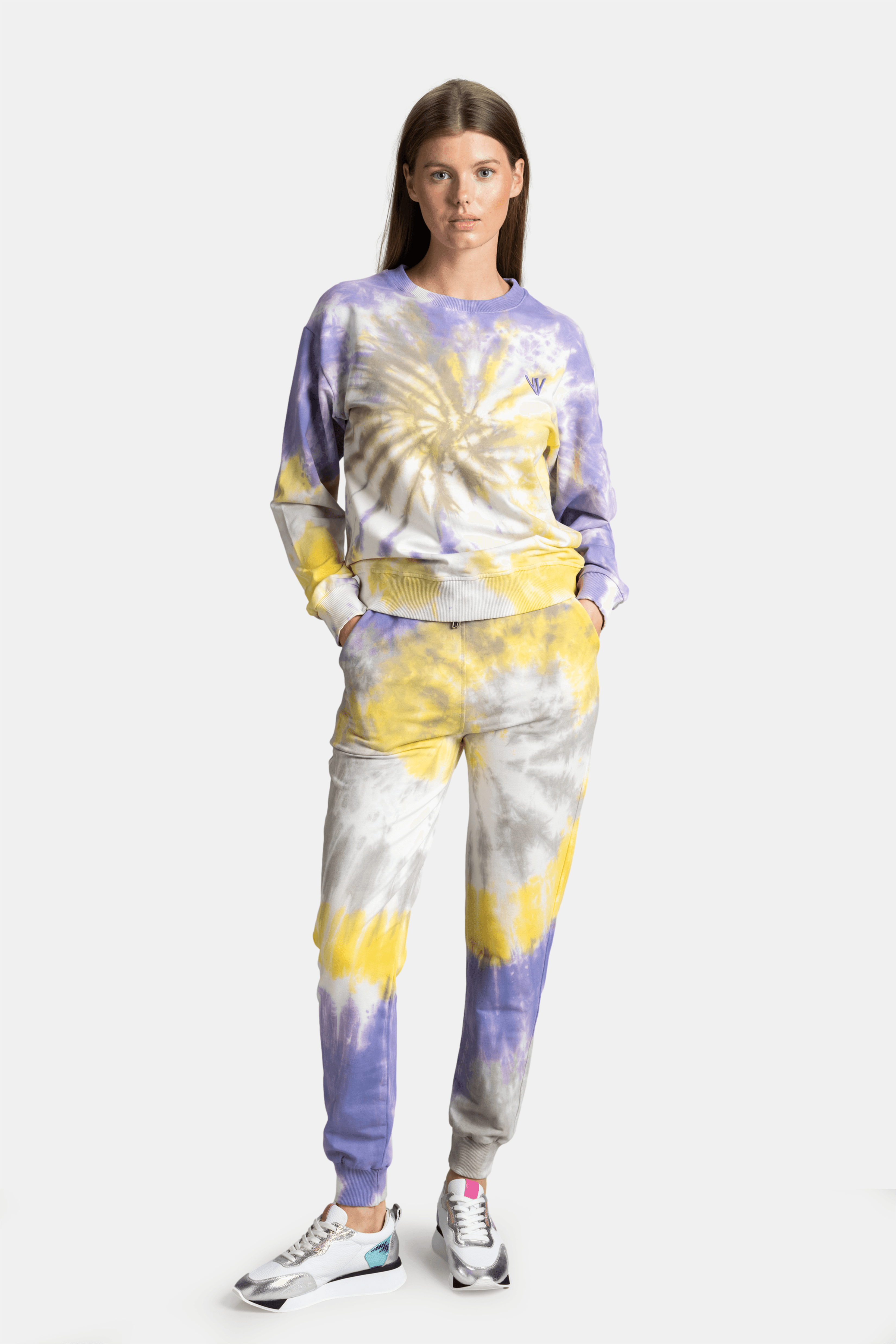 Model wearing tie-dye loungewear set in yellow and purple, capturing a relaxed yet chic look, perfect for stylish comfort at home or on the go.