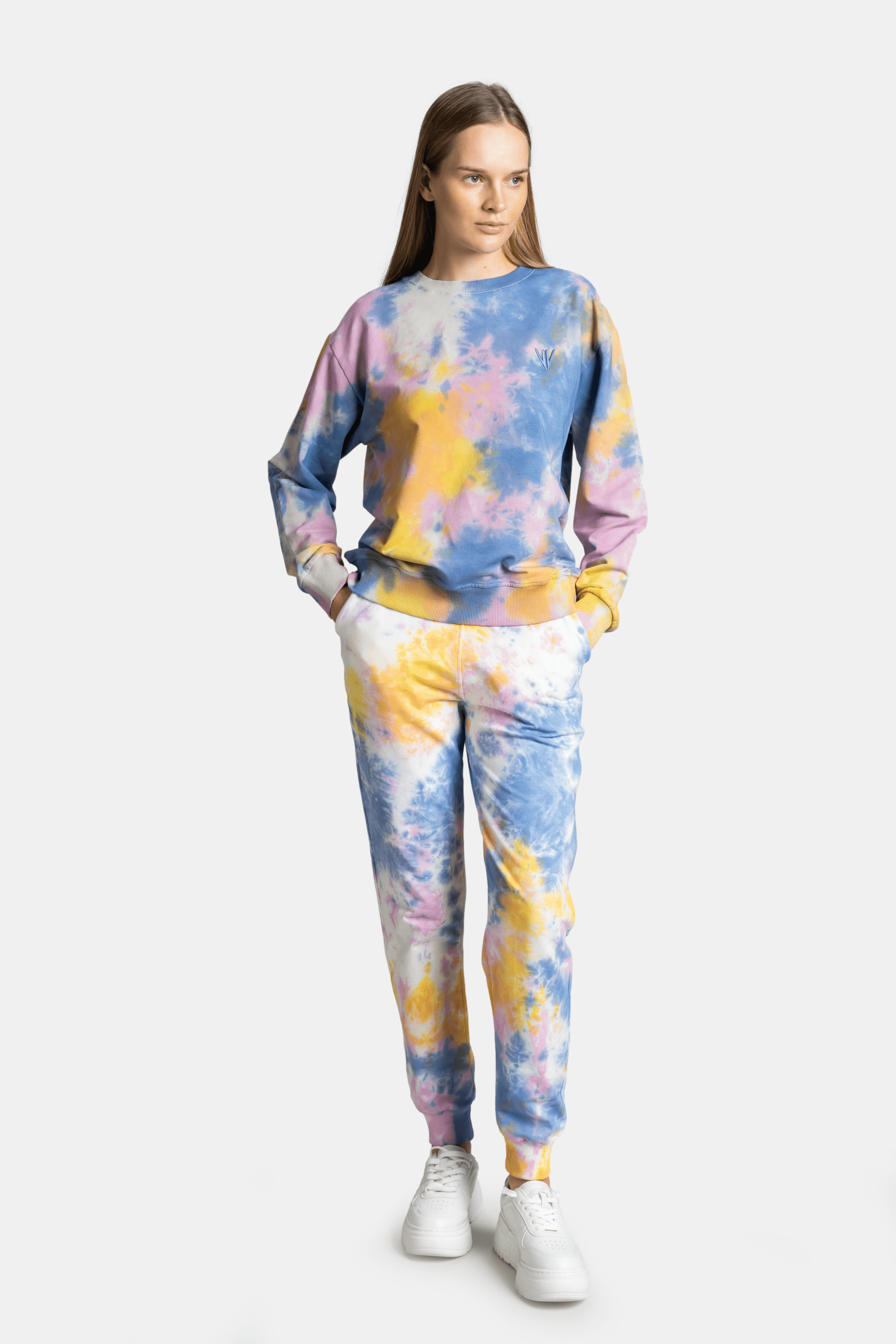 Model in front view, showing the full tie-dye tracksuit set in pastel shades with a relaxed pose.