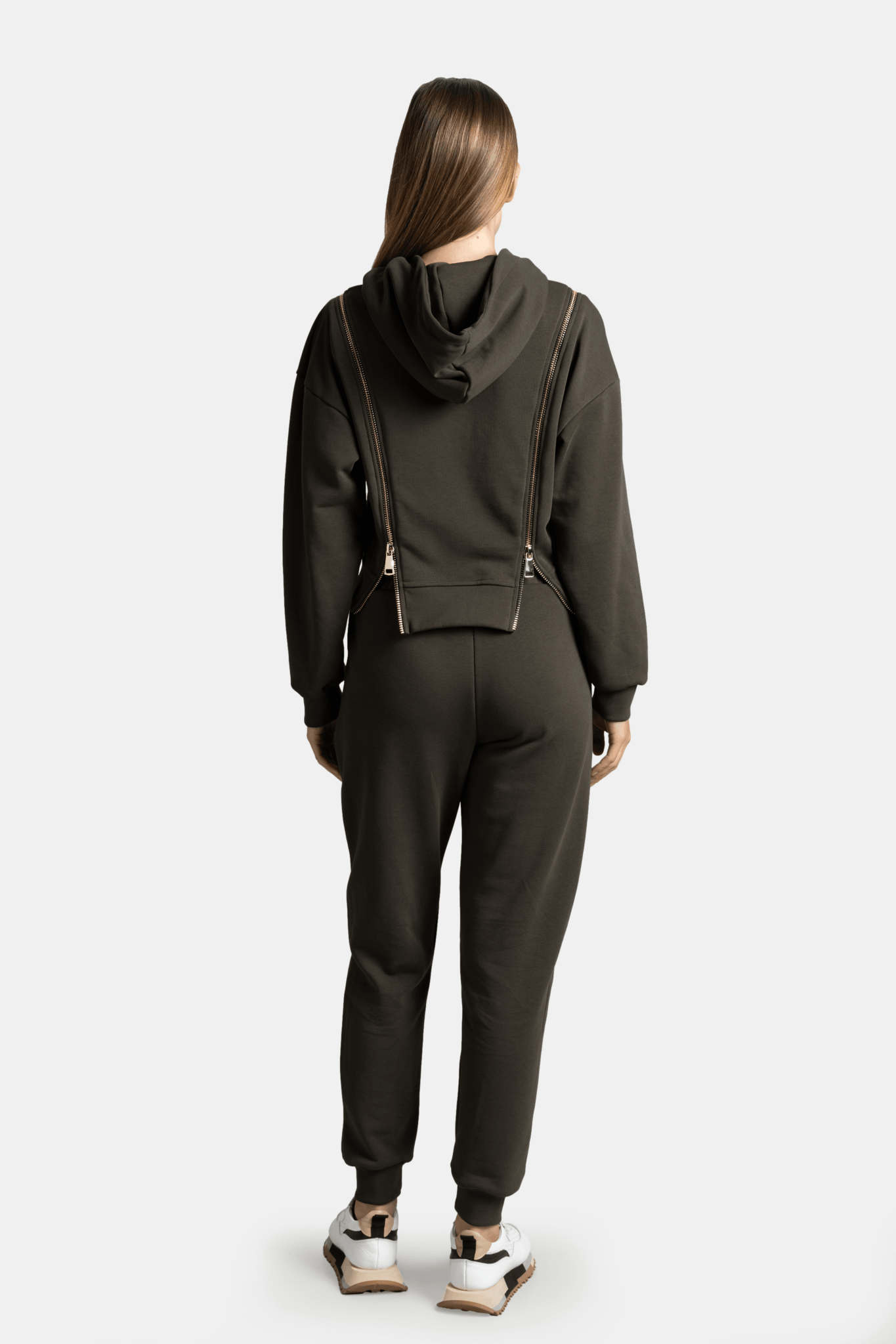 Back view of the Amina - Zip Detail Tracksuit Set in khaki, highlighting the hoodie design and the comfortable fit of the pants.