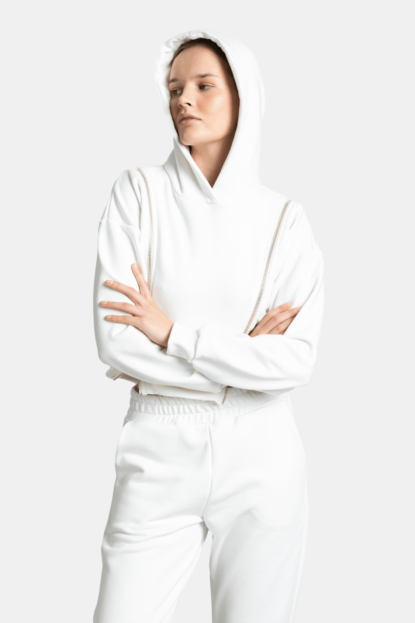Model with arms crossed, wearing the Amina zip detail tracksuit set in ecru, emphasizing the sporty yet stylish design.