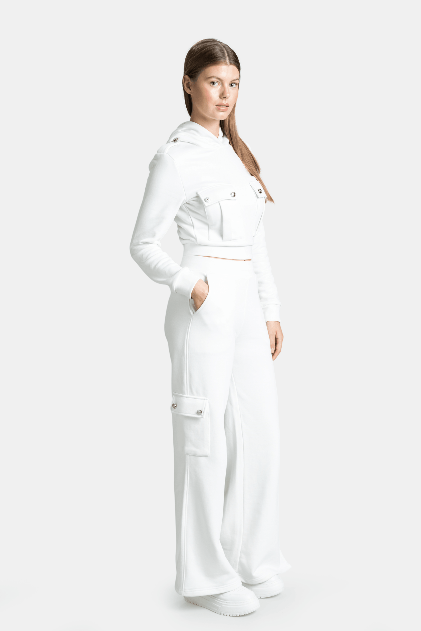 Cambria - Pocket Detail Tracksuit Set in Ecru, side profile view with model’s hands in pockets, emphasizing the relaxed fit and practical pocket design on the sides.