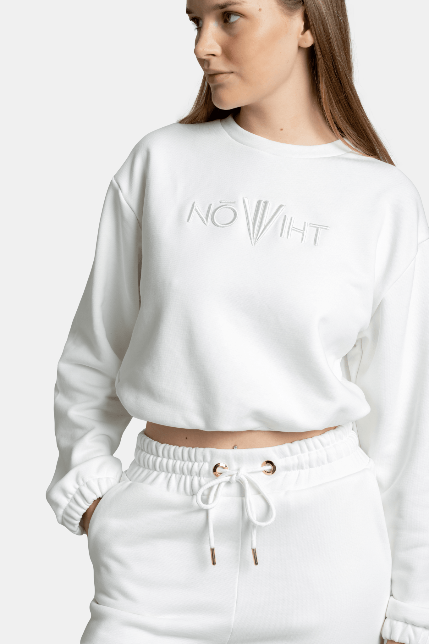 Model in a white Nowiht tracksuit set, showcasing the full design and comfortable fit for a relaxed and casual look.
