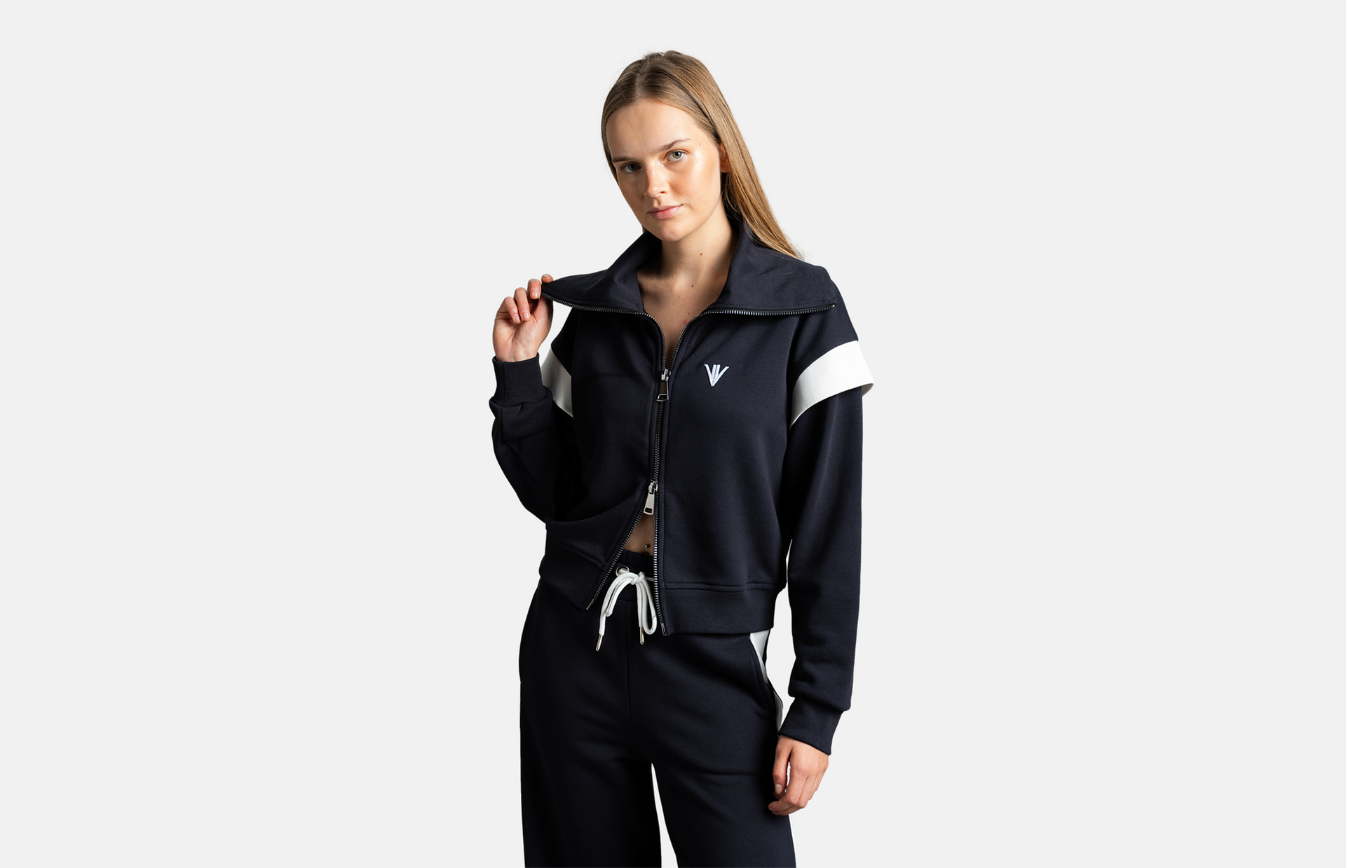 Model wearing NOWIHT navy jacket with white shoulder stripe, featuring a zip-up design for a modern and sporty look