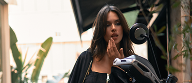 Model wearing black NOWIHT outfit in an urban setting, representing modern street style and comfort